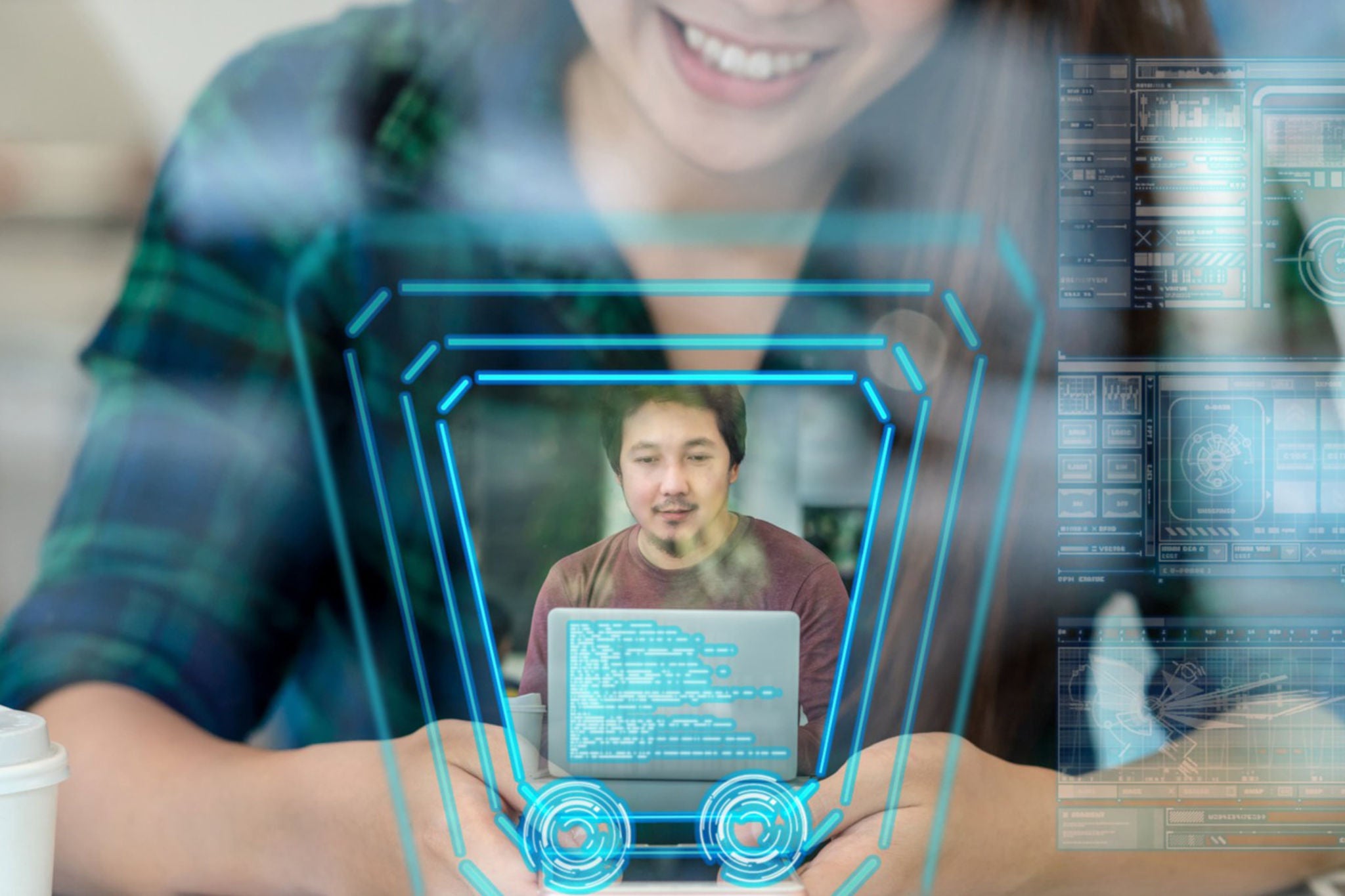 The image shows a person smiling while using a device, possibly a laptop or tablet, with a holographic overlay of a man displayed on their screen.