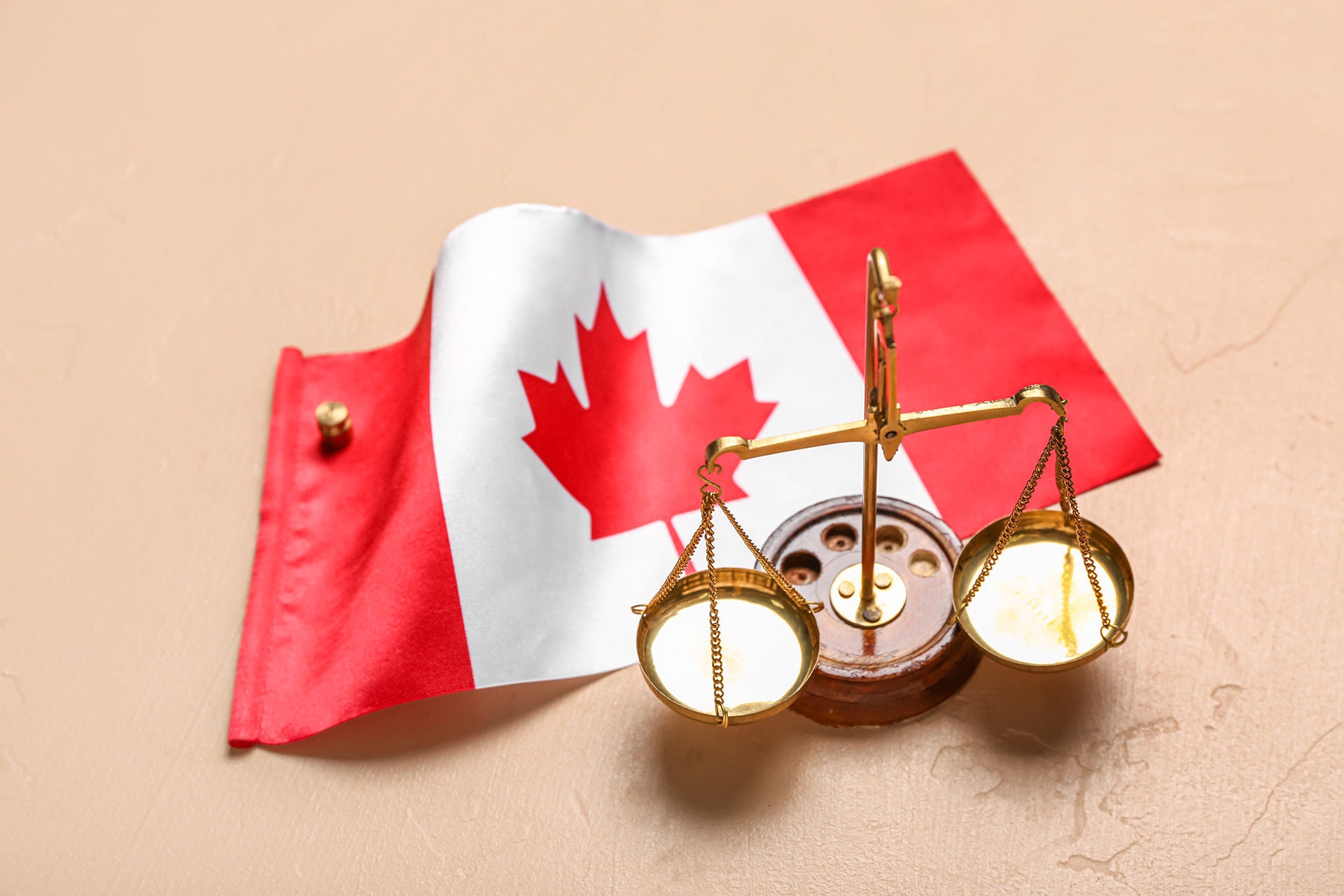 flag of canada with justice scales on beige background