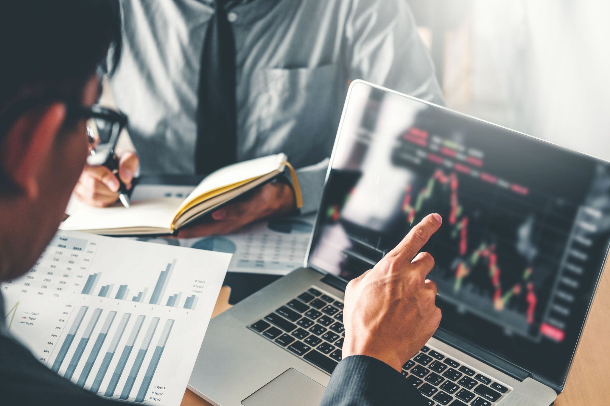 Business Team Investment Entrepreneur Trading discussing and analysis graph stock market trading