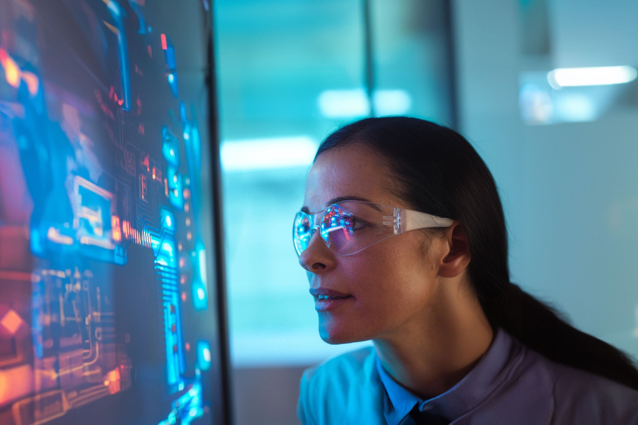 Scientist in glasses looking at screen