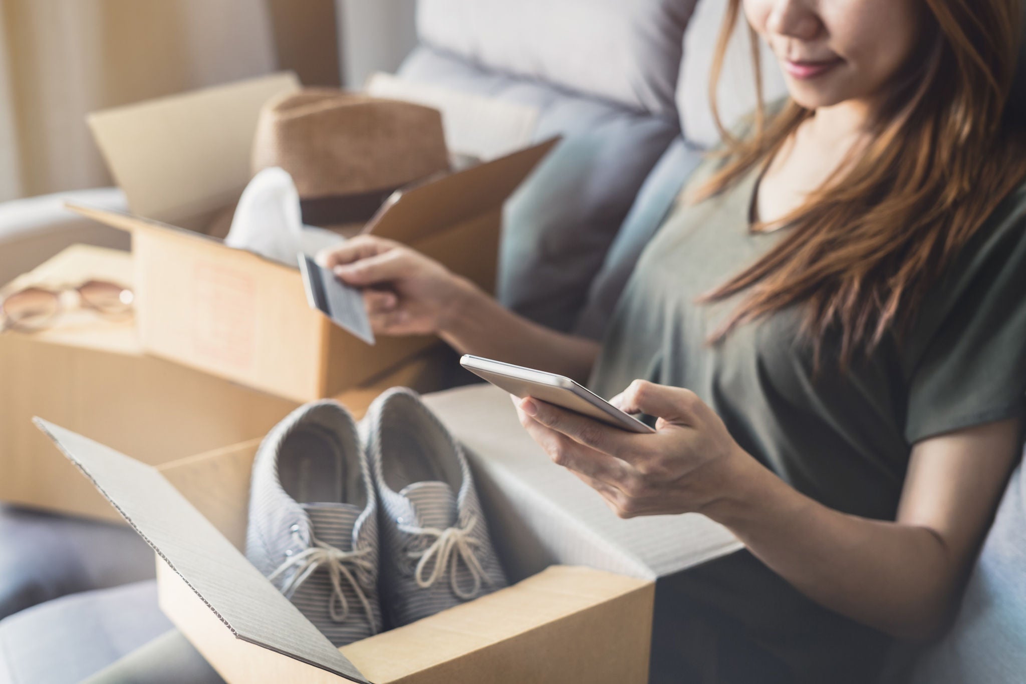 Woman online shopping in living room