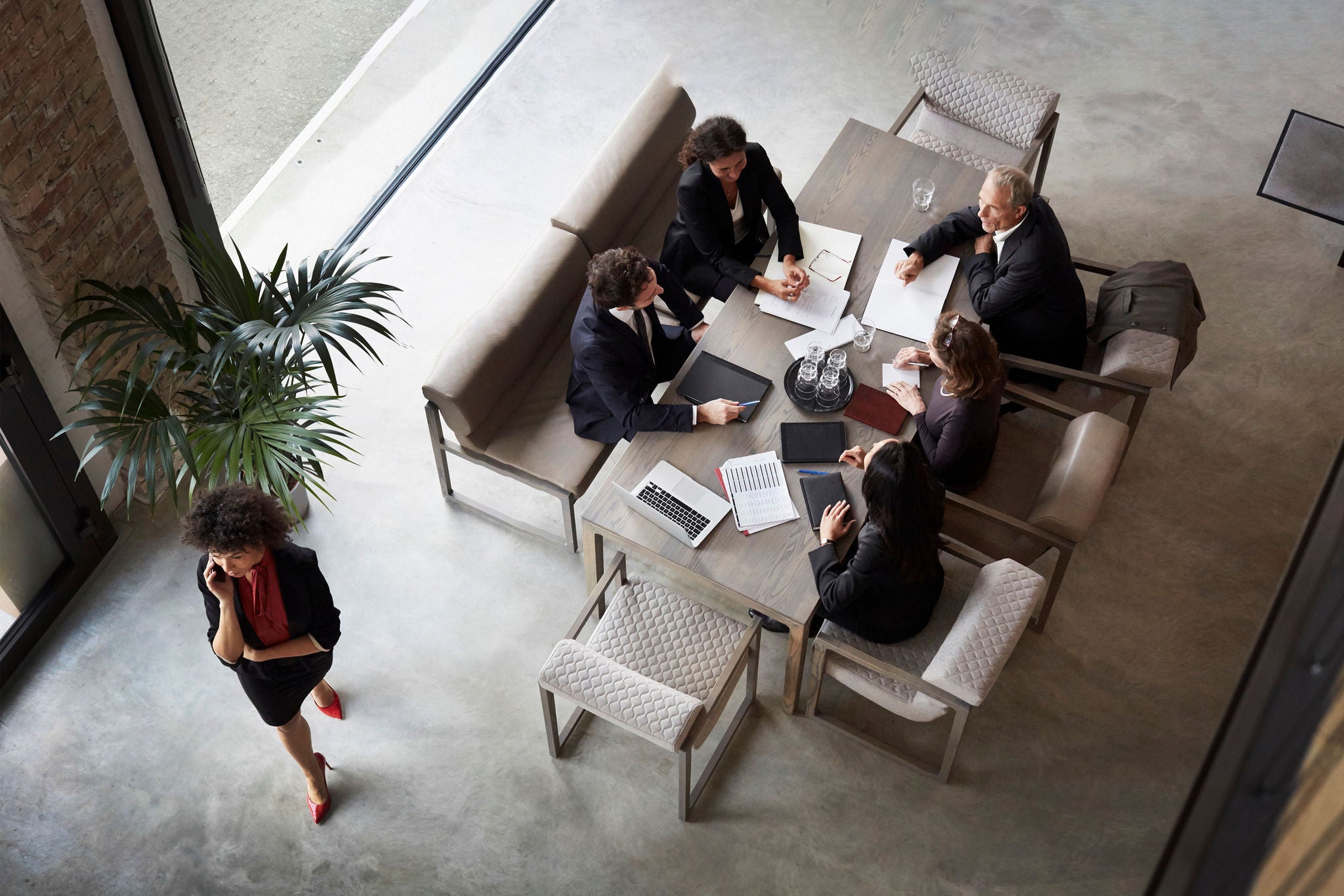 Team of financial advisors planning with business colleagues during meeting at law firm