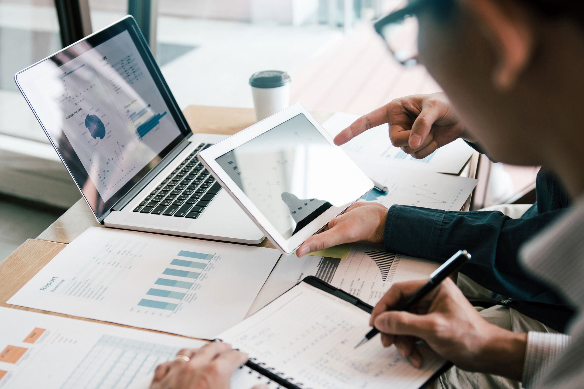 Business partnership coworkers using a tablet to analysis graph