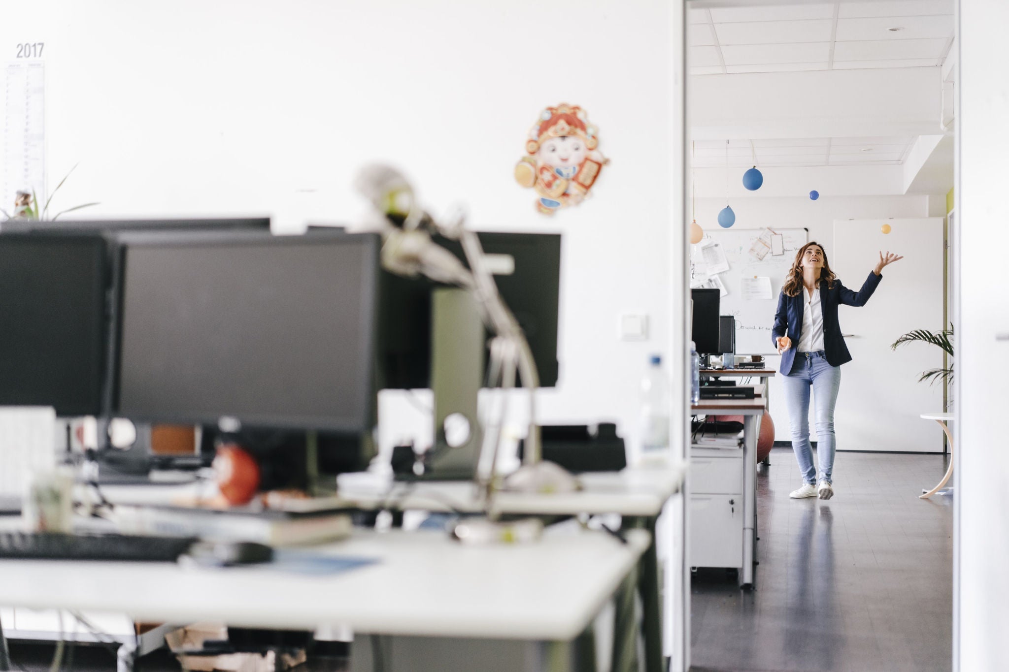 Businesswoman juggling balls office