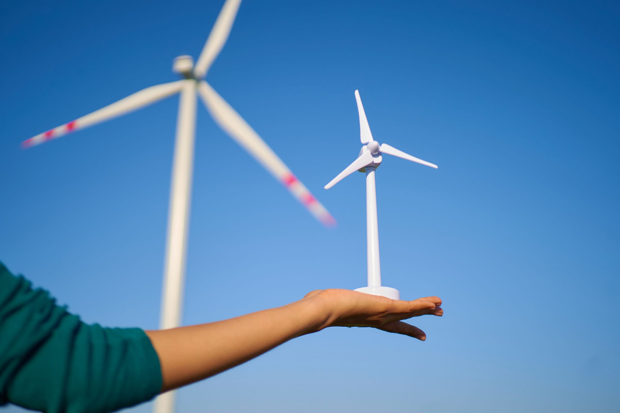 A Hand Holding Wind Turbine Prototype Model Miniature