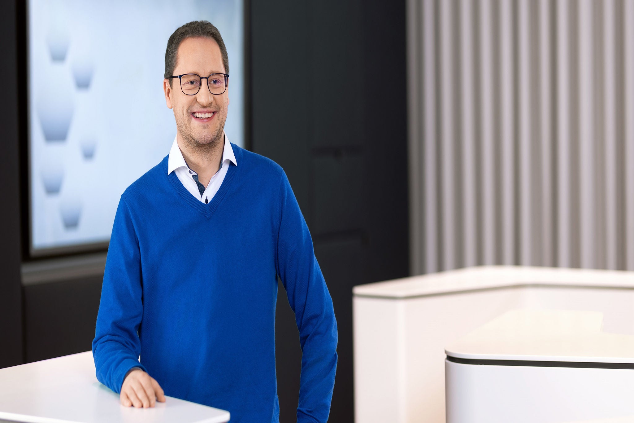 man standing and smiling at camera