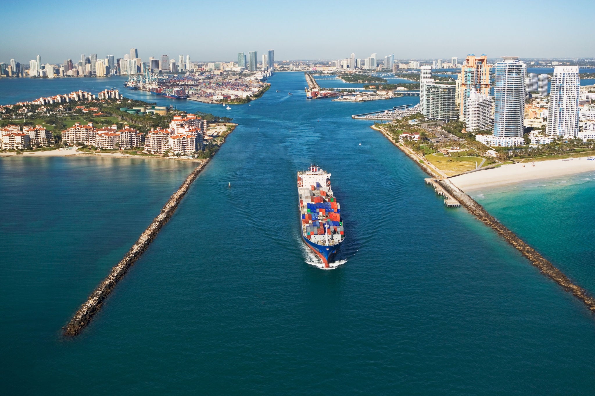 EY aerial view of waterfront city cargo ship