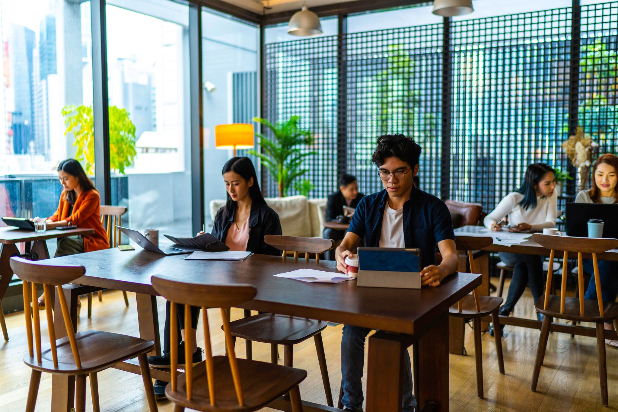 Asians Millennials busy working in co-working space.