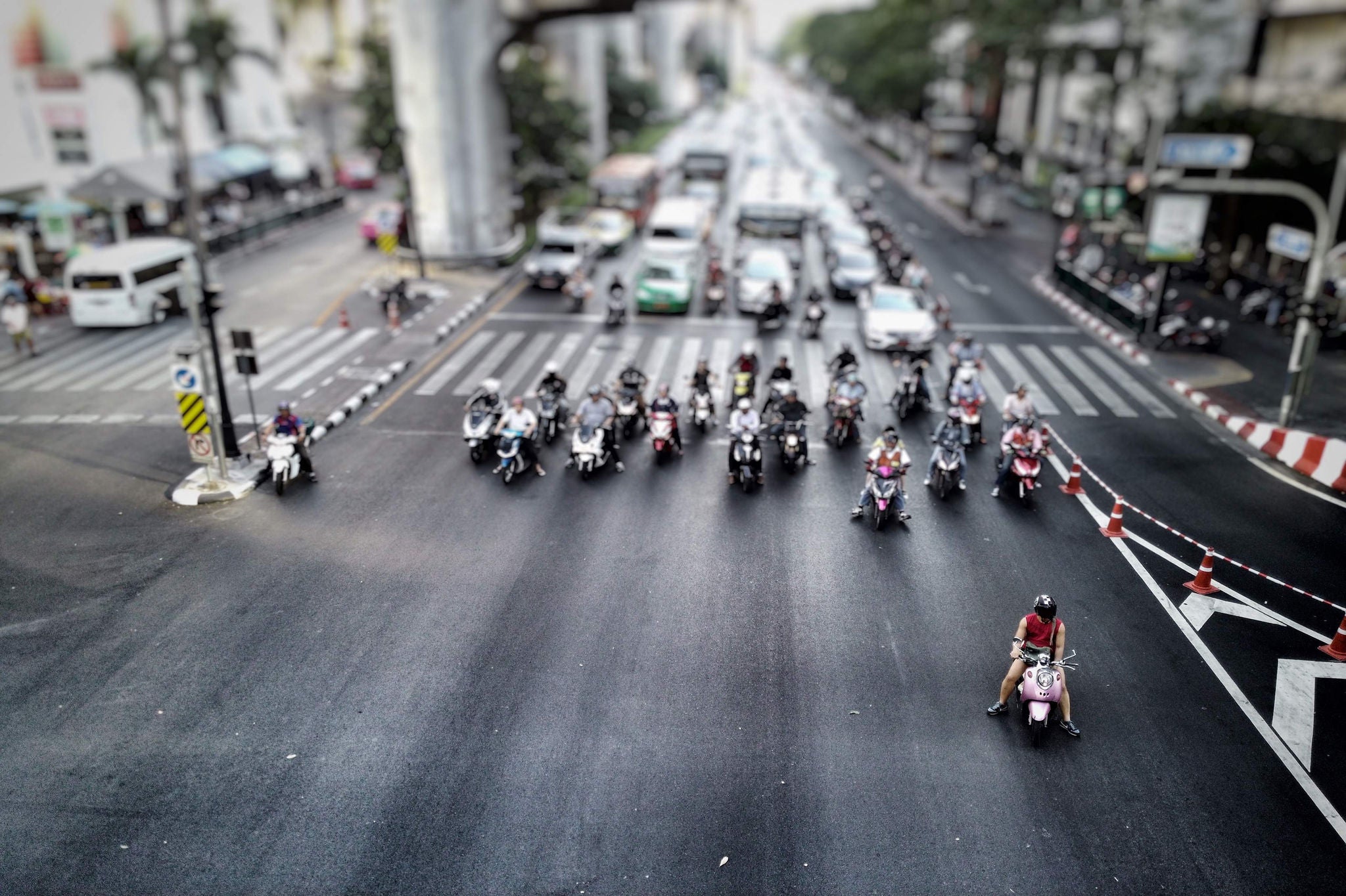 Scooters wait traffic lights bangkok