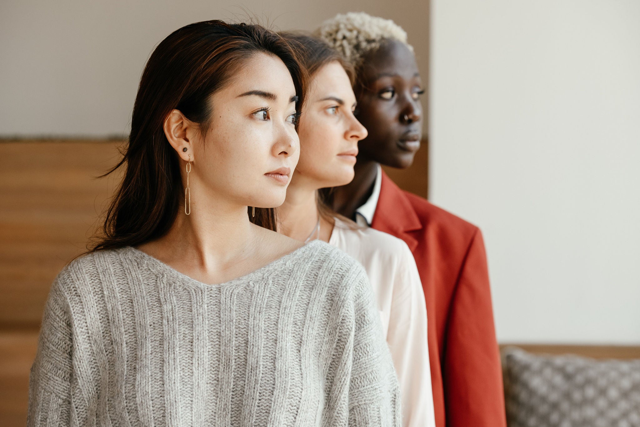 Image of three women standing next to other