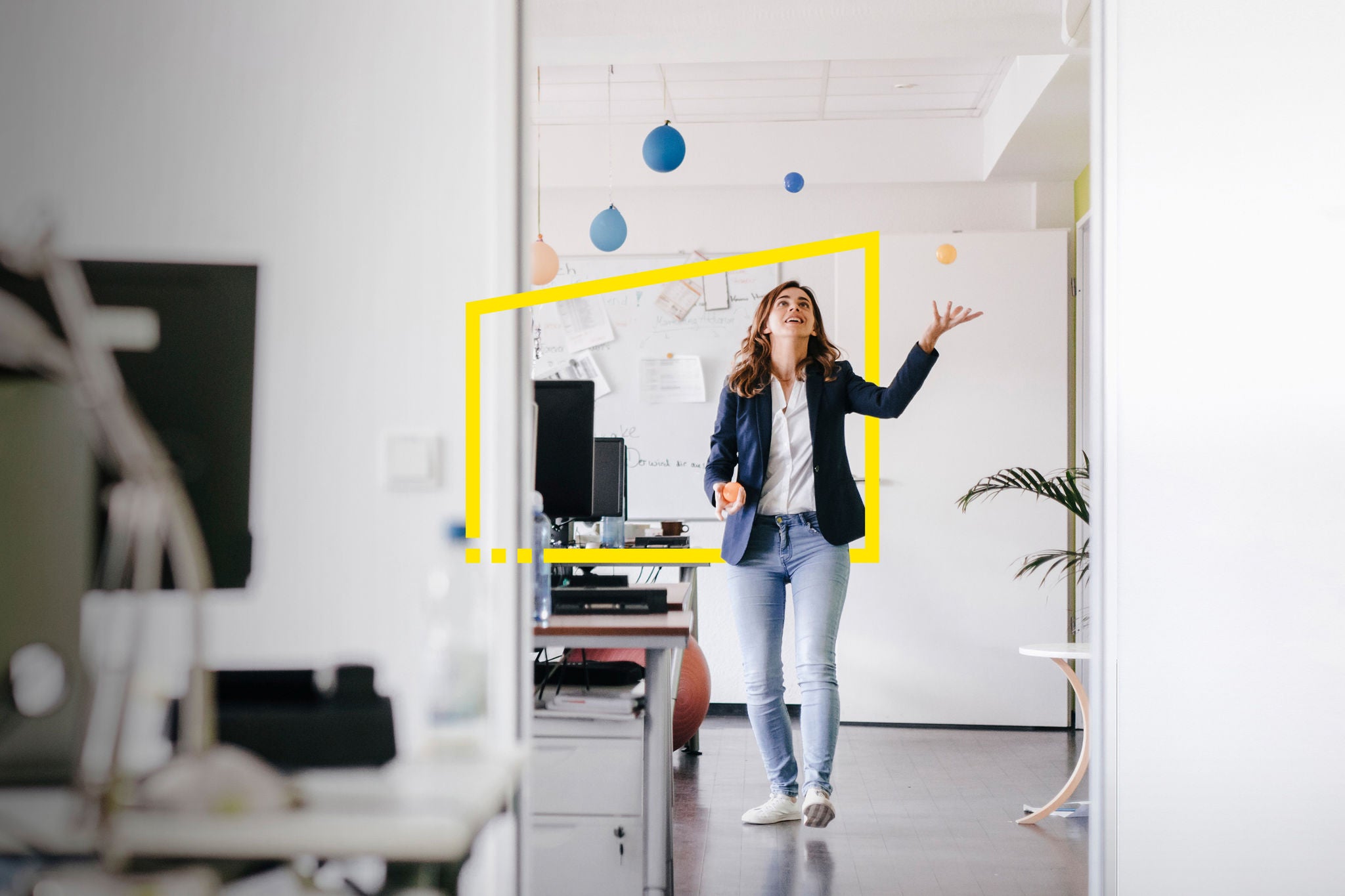 Ey businesswoman juggling balls office static