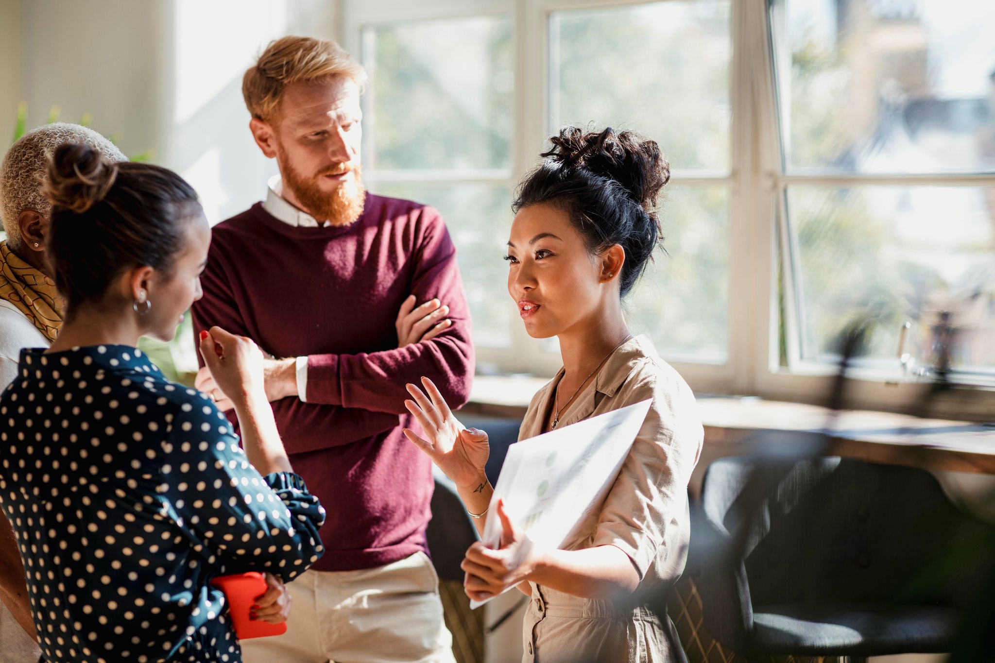 Colleagues standing whilst discussing a project