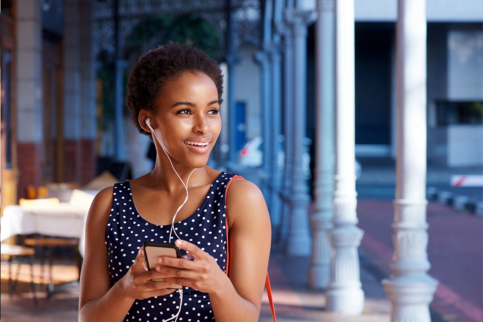 A lady is listening  music by putting ear phones