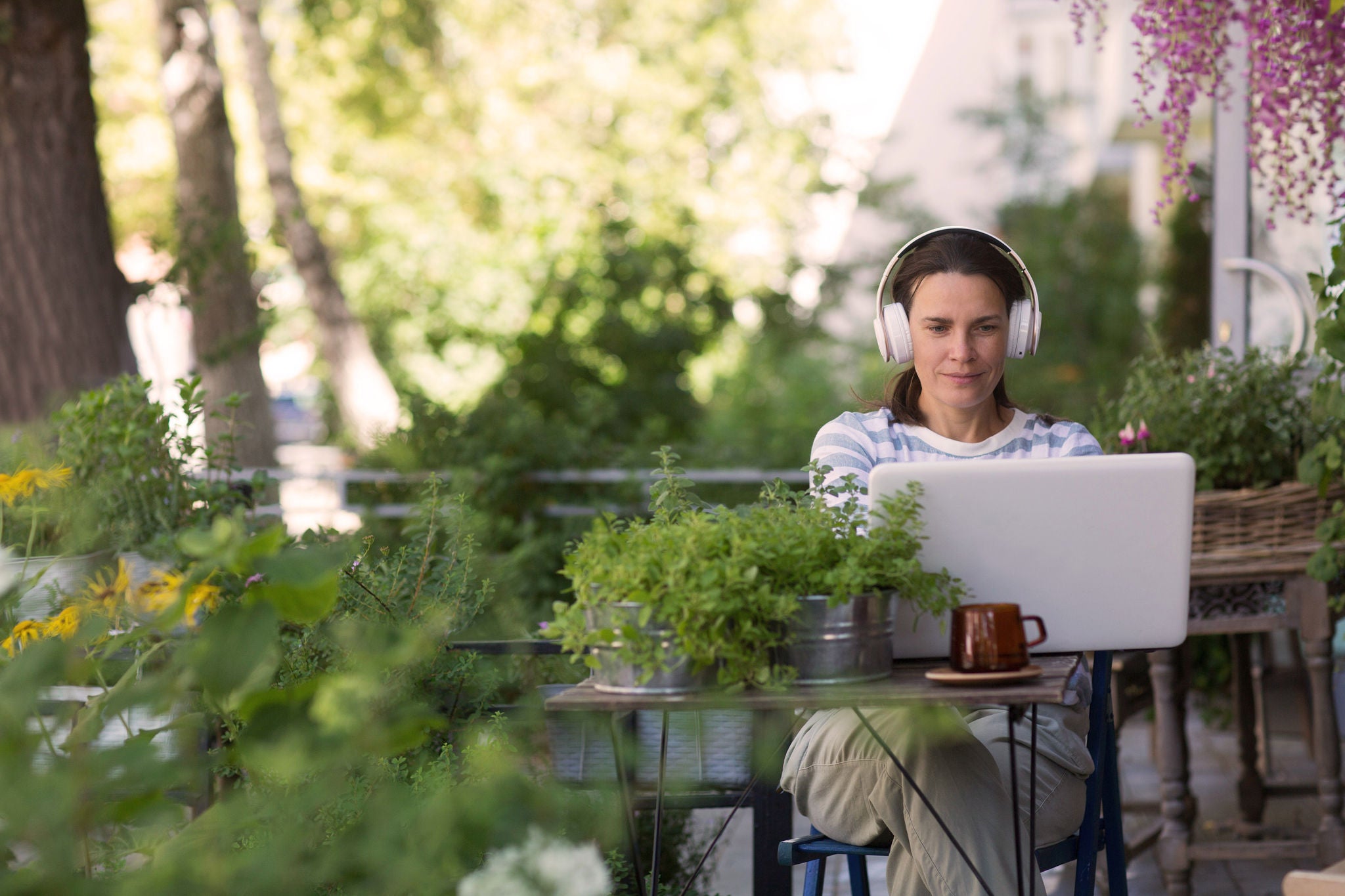 Person working in laptop wearing headset