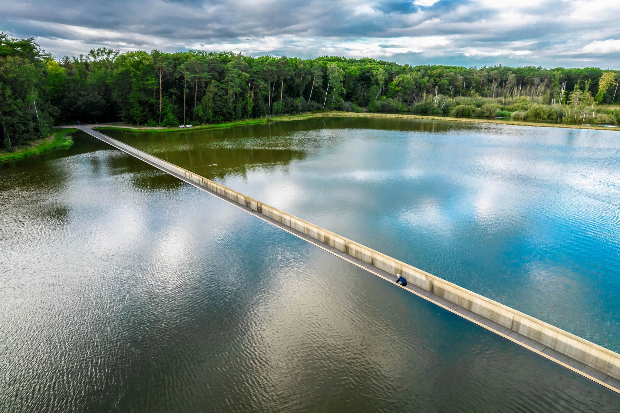 "Cycling through Water" is cool experience in Belgium with bicycle lane crossing pond thought the water cycling under the water surface with fun visual effect. Belgium.