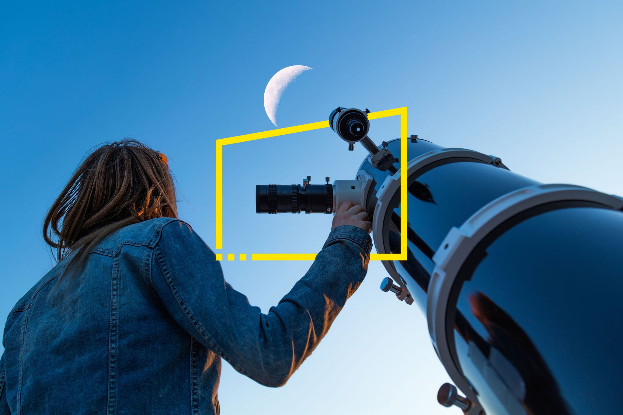 Girl looking at the Moon through a telescope.