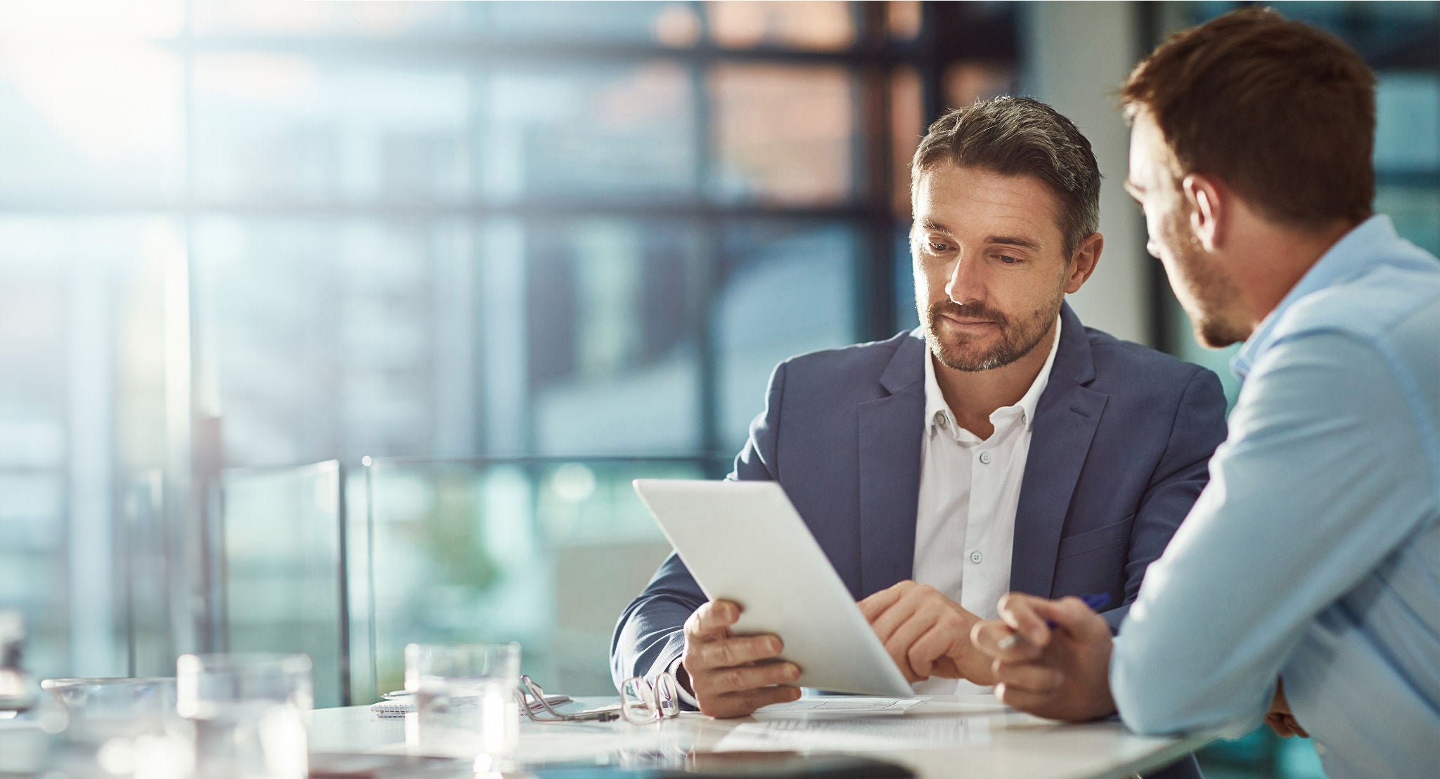 Teamwork meeting, tablet and business people in office workplace. Collaboration, technology and workers, men or employees with touchscreen planning sales, research or financial strategy in company.