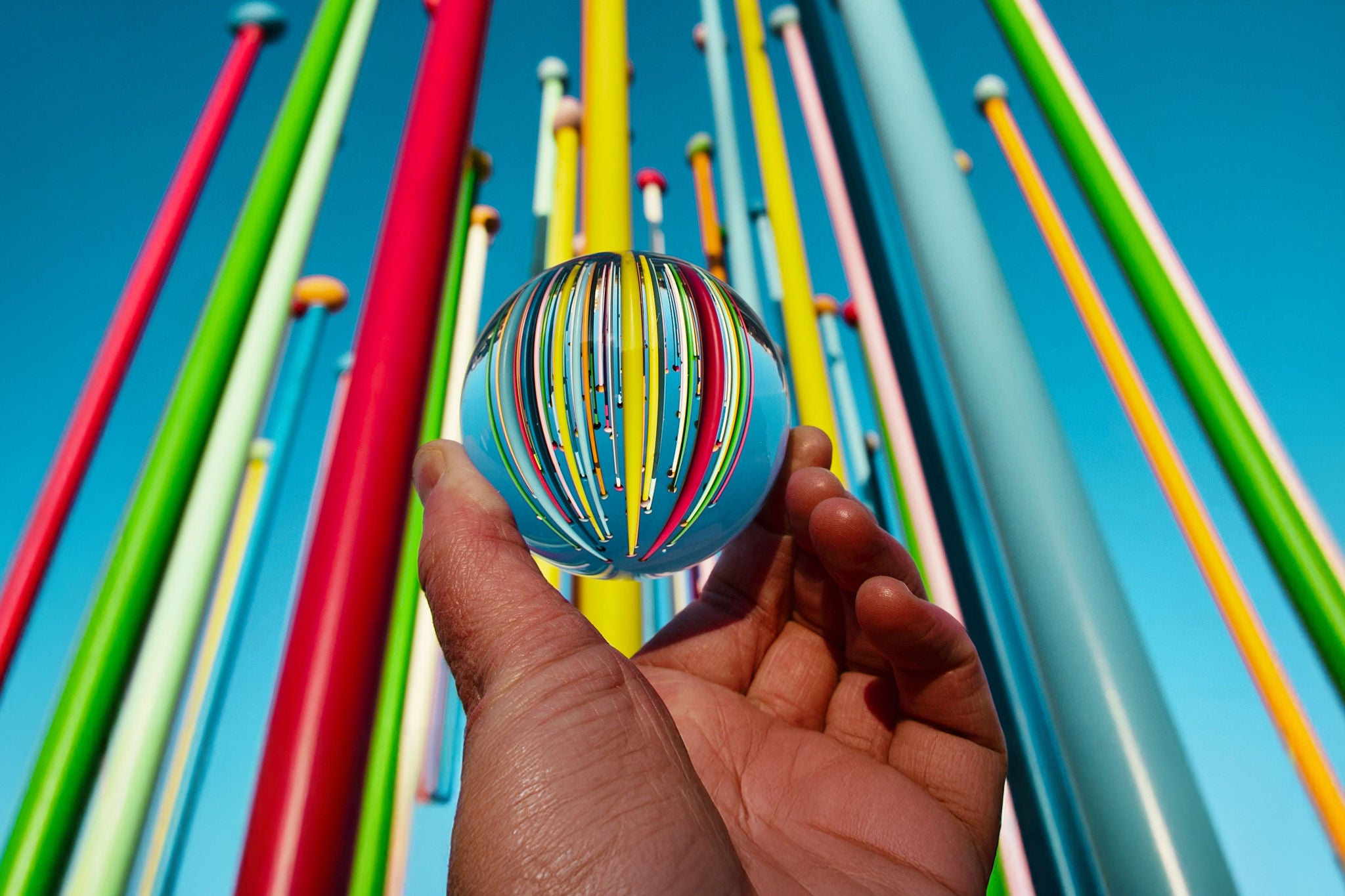 close-up of hand holding multi colored straws