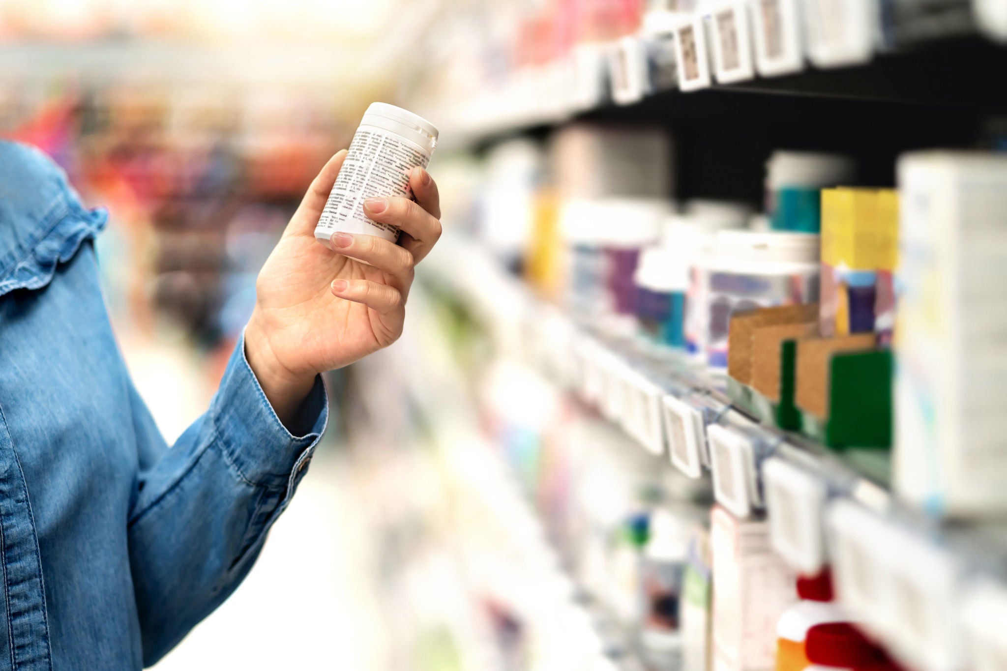 women buying medicine or vitamins in a store