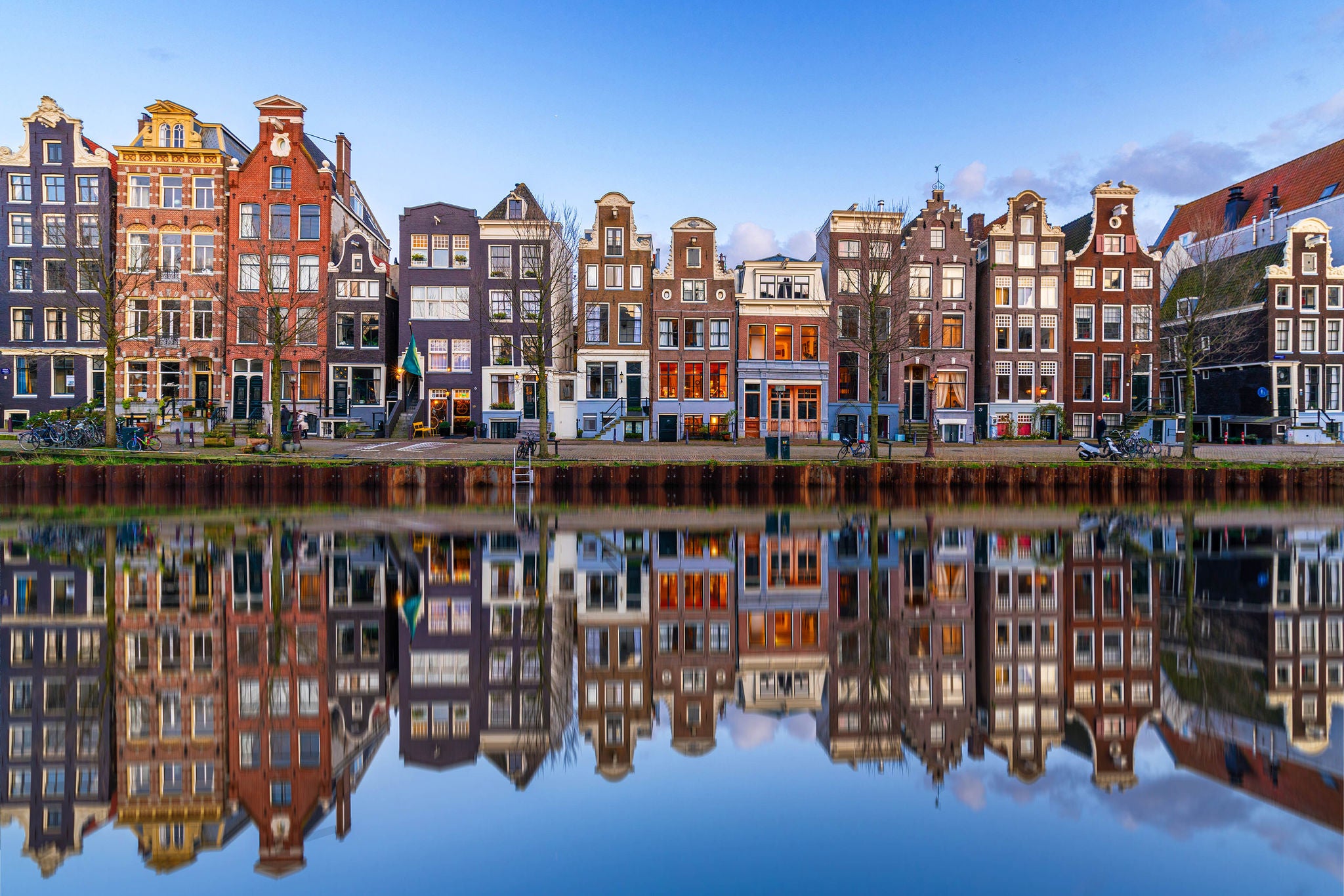 This is a photo of typical architecture of old Amsterdam houses on the Herengracht canal. It was shot during sunset.