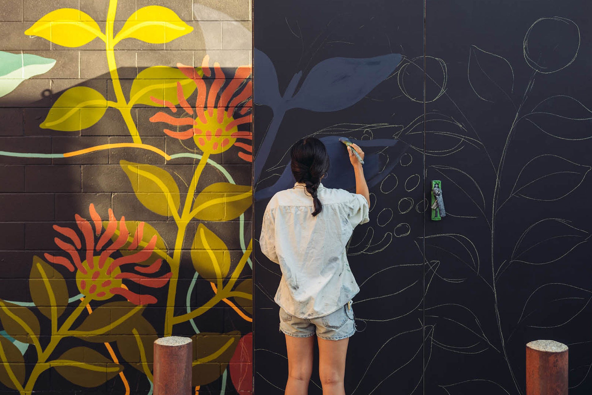 women painting on wall