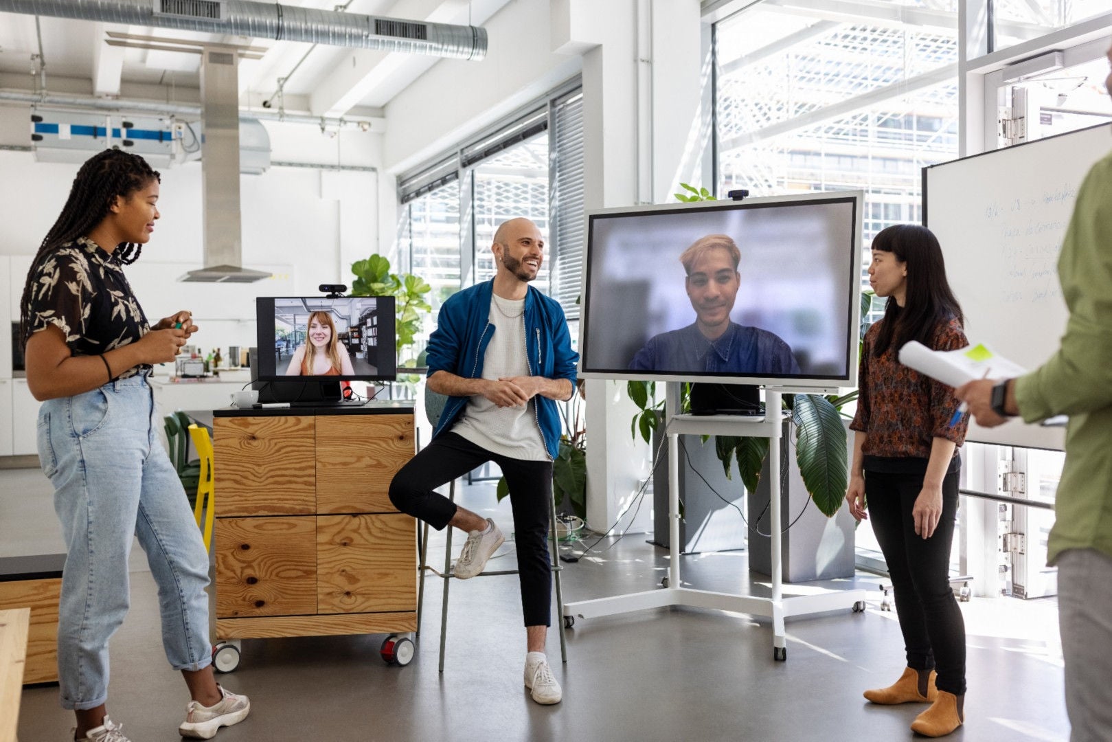 people-discussing-standing-infront-of-computer