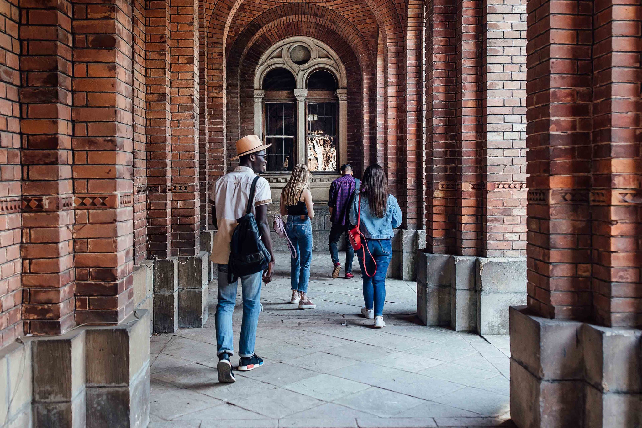 Portrait of successful students walking to classes near college