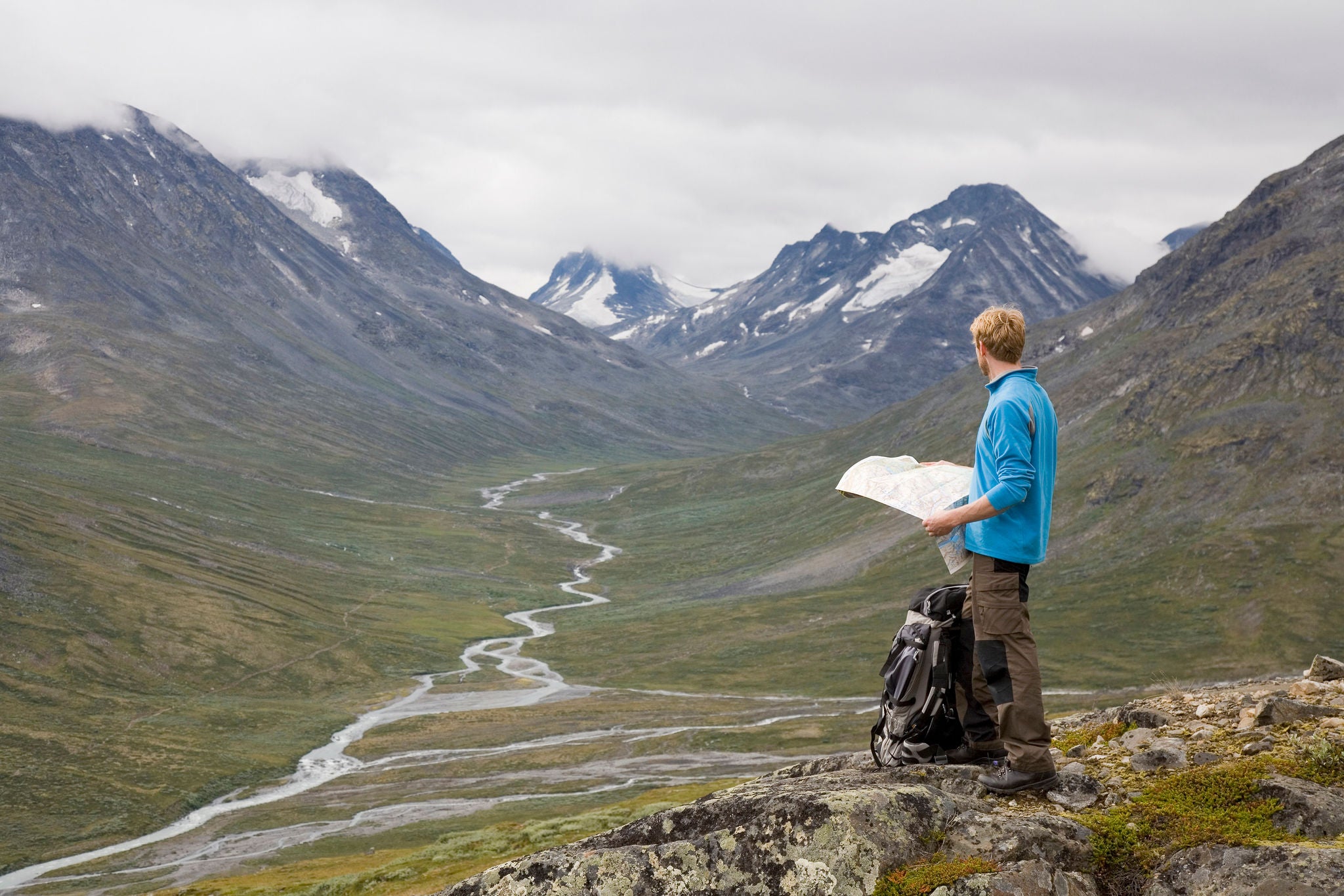 Man with map in mountain surroundings