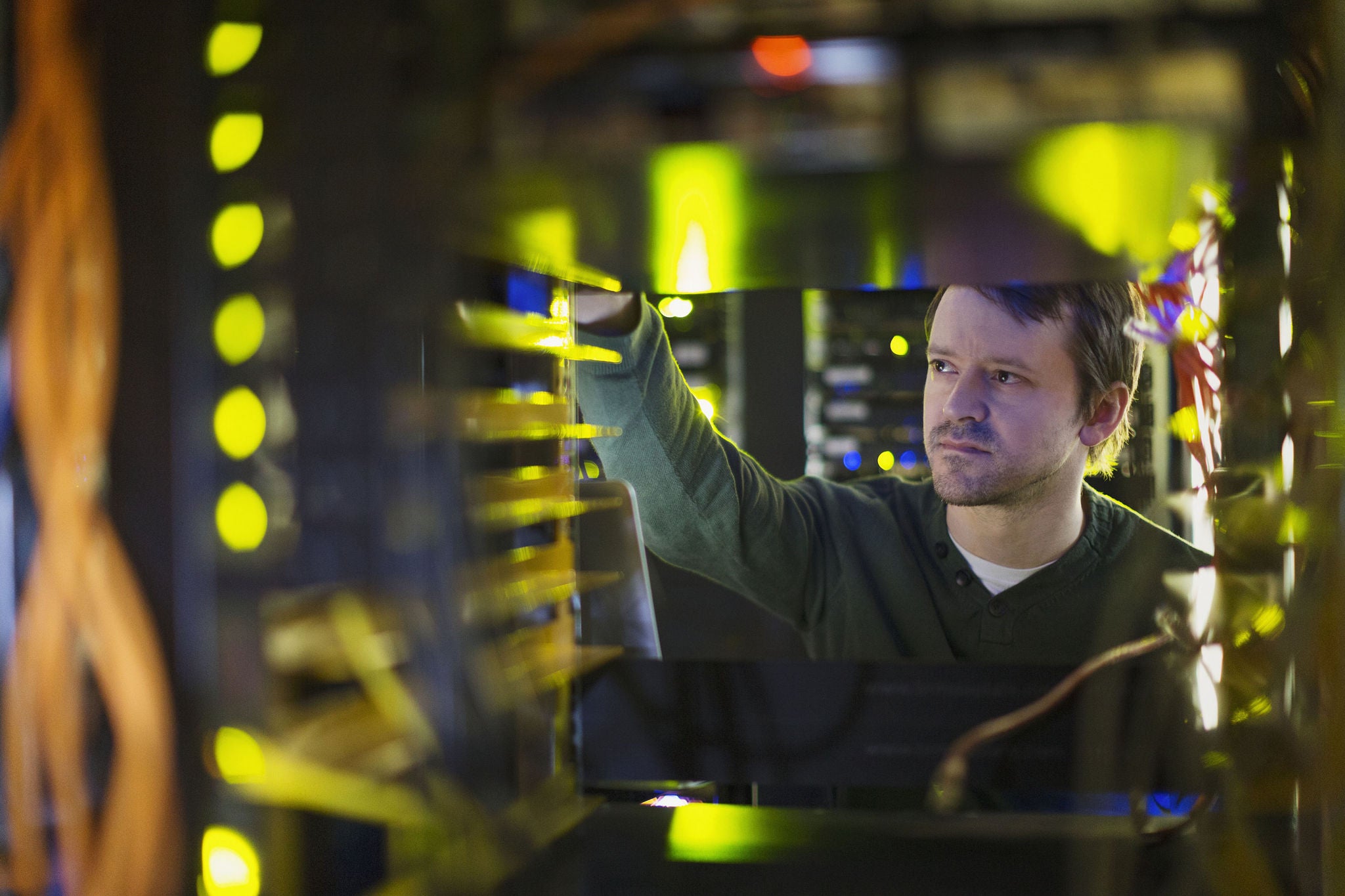  - Server room technician working on server panel