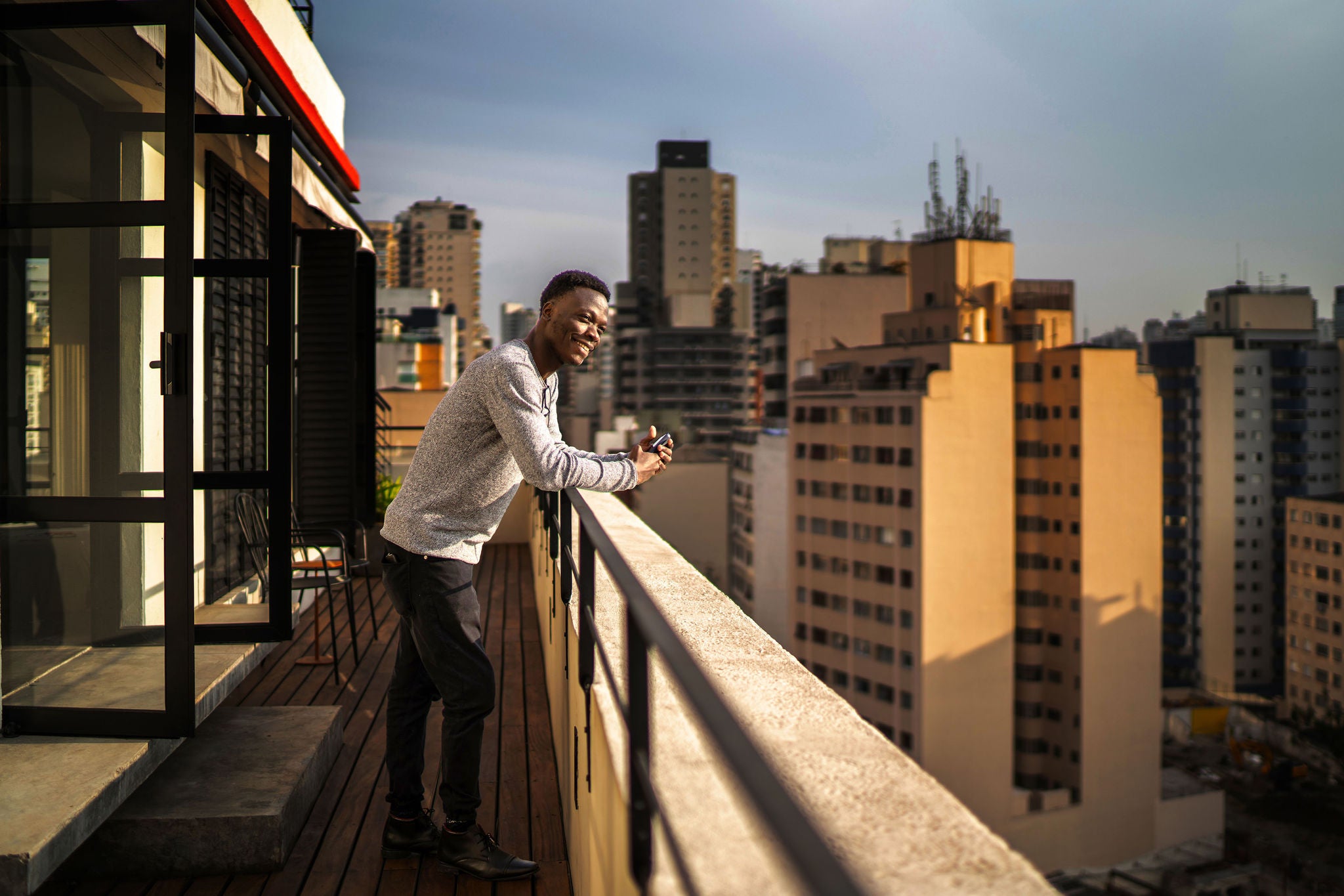 Young man contemplating from building terrace