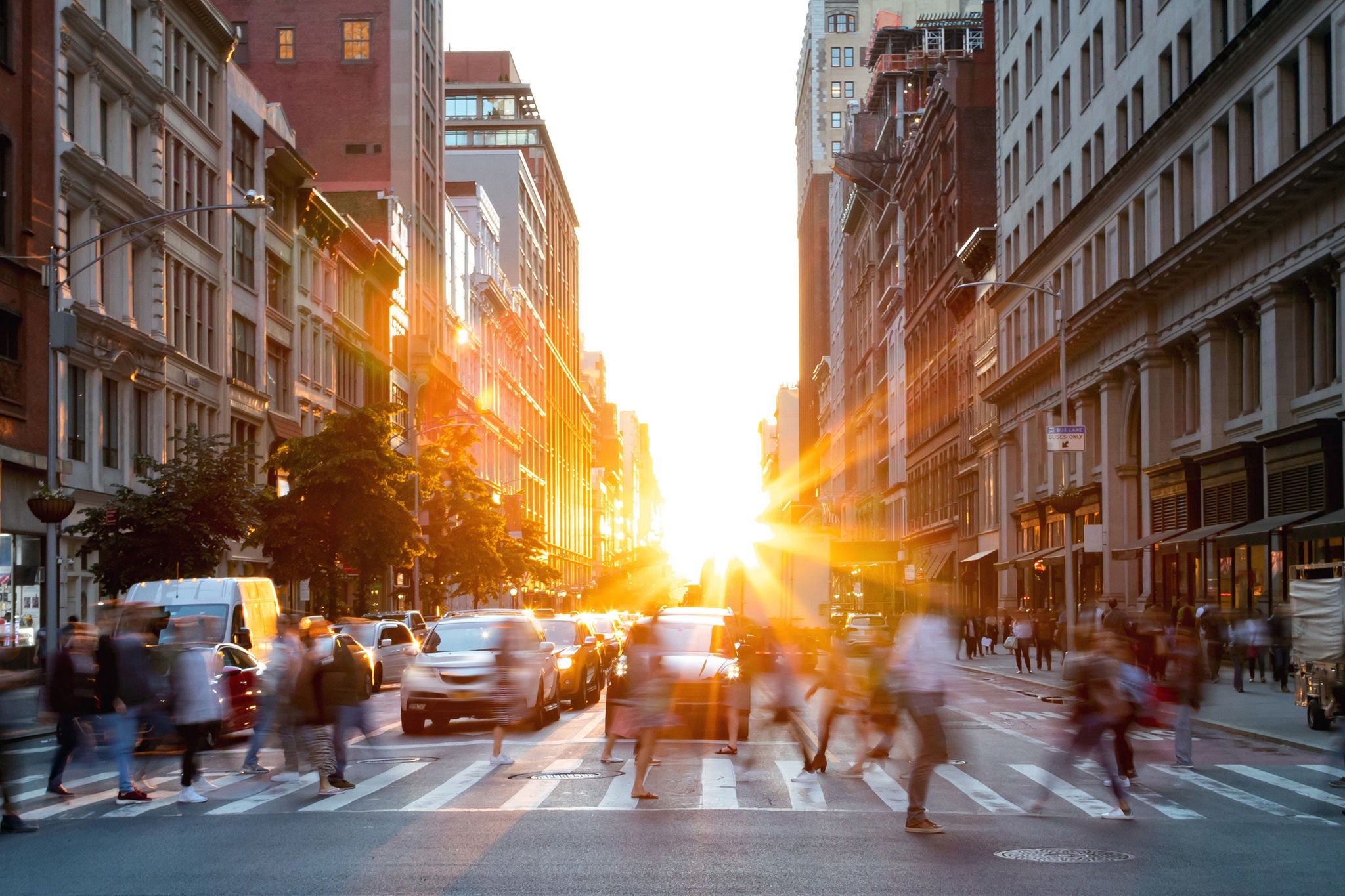 Crowds of people walking through city intersection