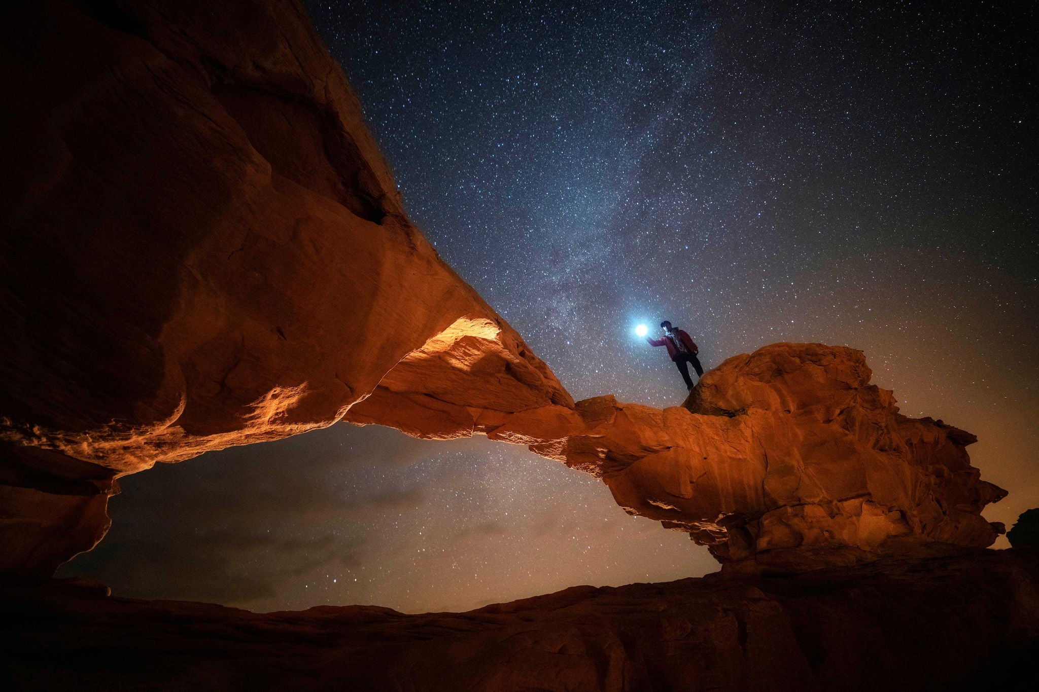 Night and star scene of stone arc in wadi rum jordan