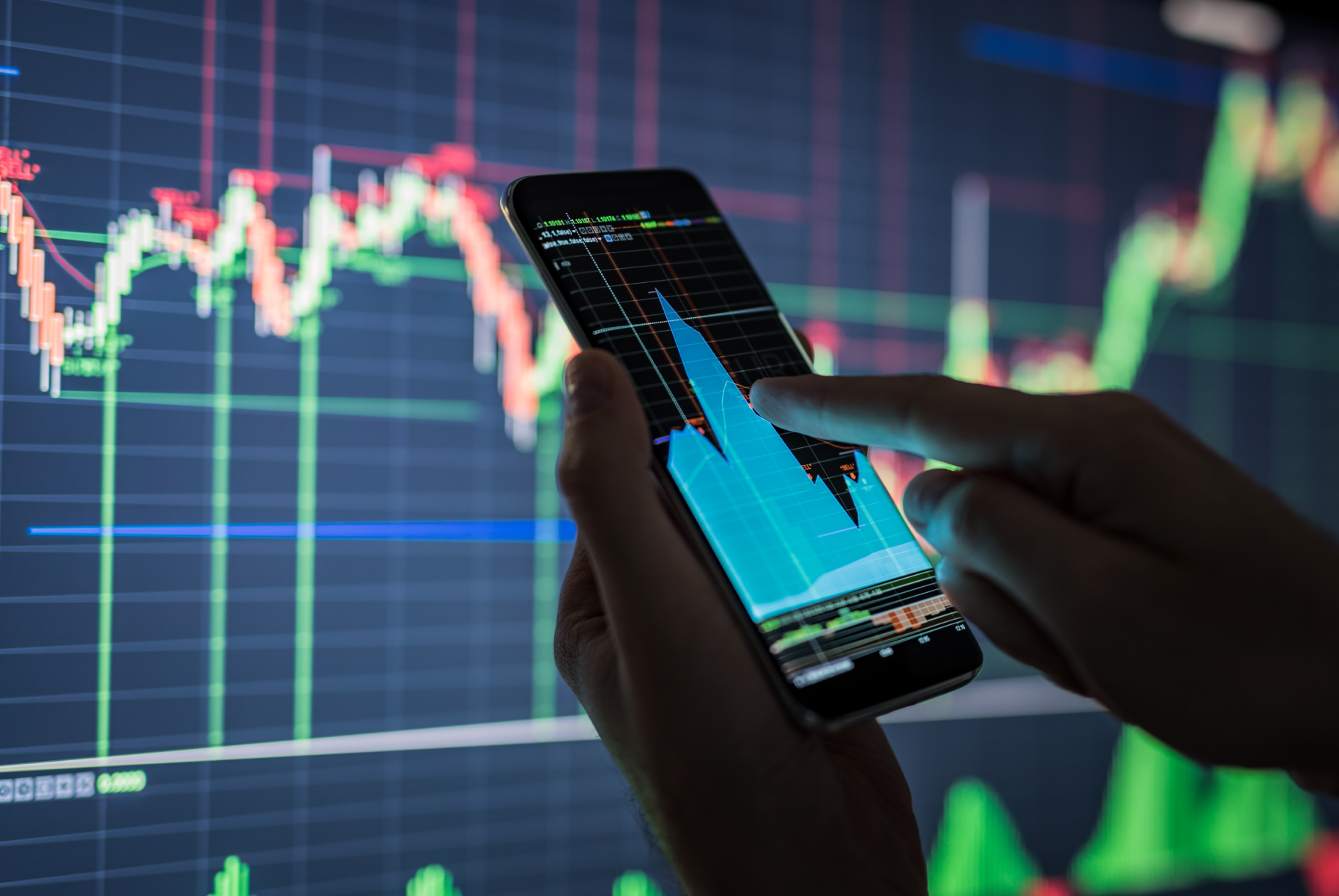 Businessman checking stock market data on his mobile device