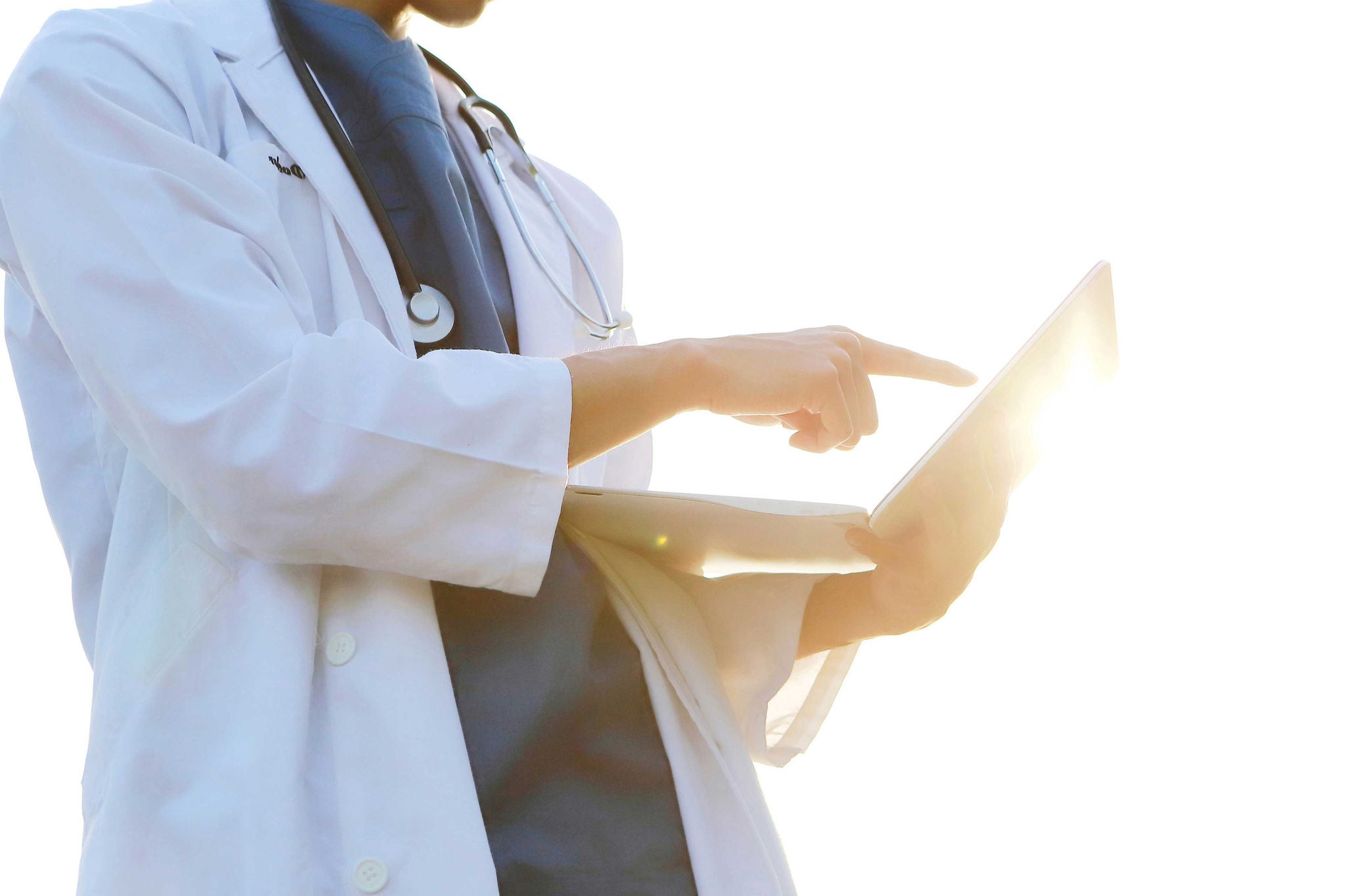 Doctor using laptop outdoors