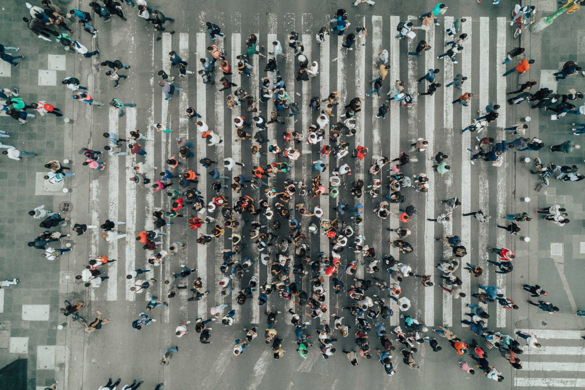 People are crossing the road through zebra crossing