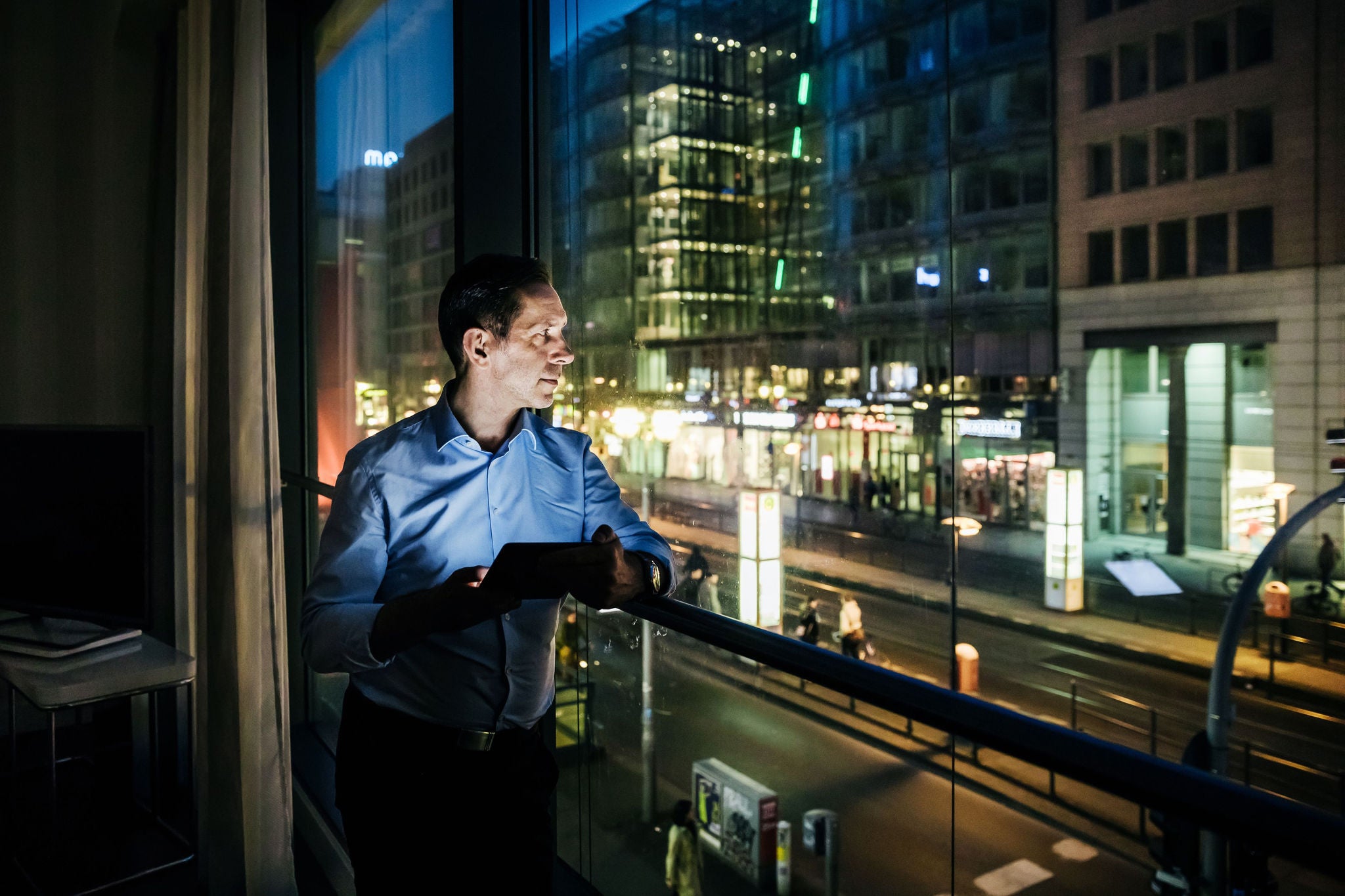 Businessman looking outside his room