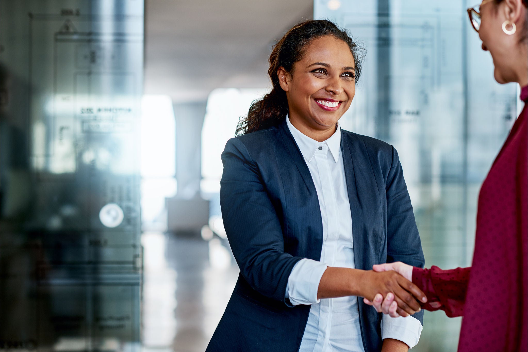 Photograph of EY employee's shaking hands each other