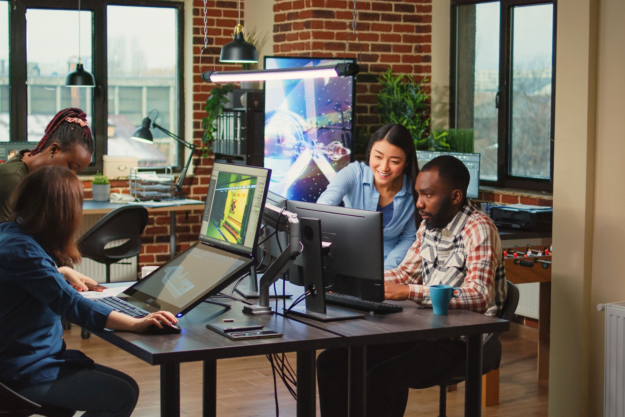 Modern technology studio employees using computers to develop new graphics interface in office, doing teamwork to create professional content. Working with 3d software to render on pc.