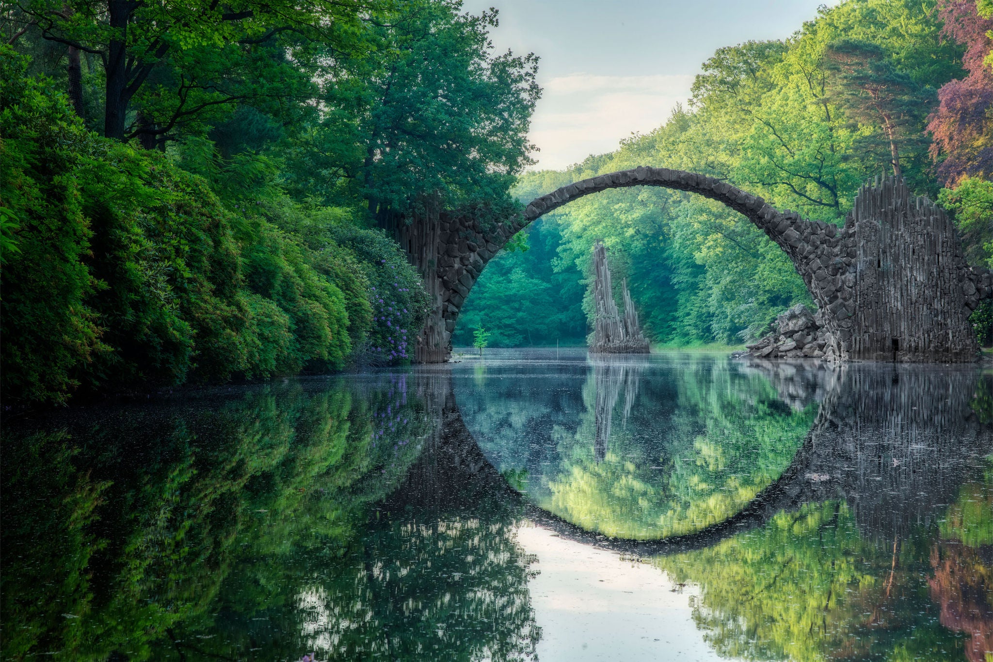 The reflections of trees in the crystal clear river