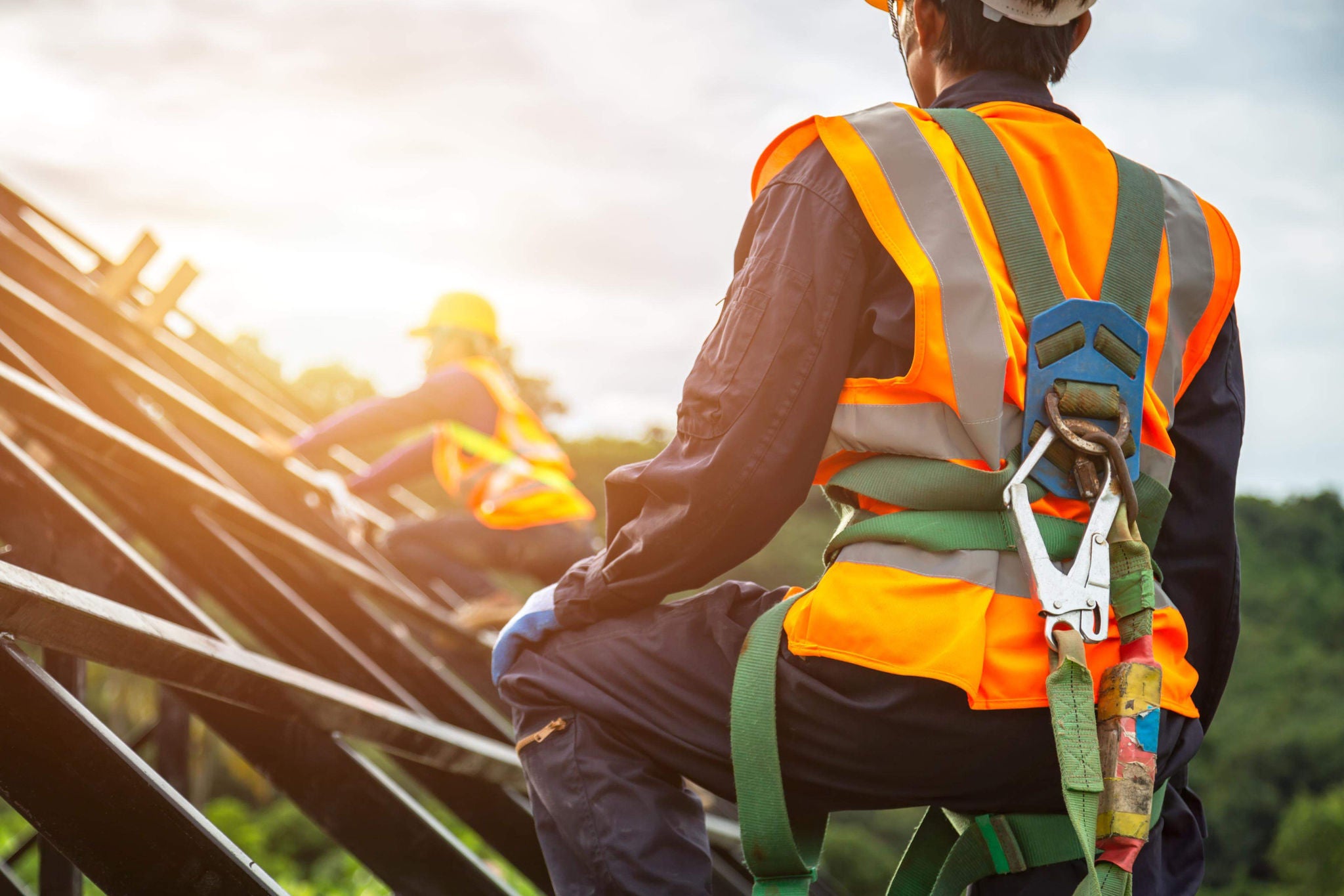 A worker is  standing on the top of constructed building