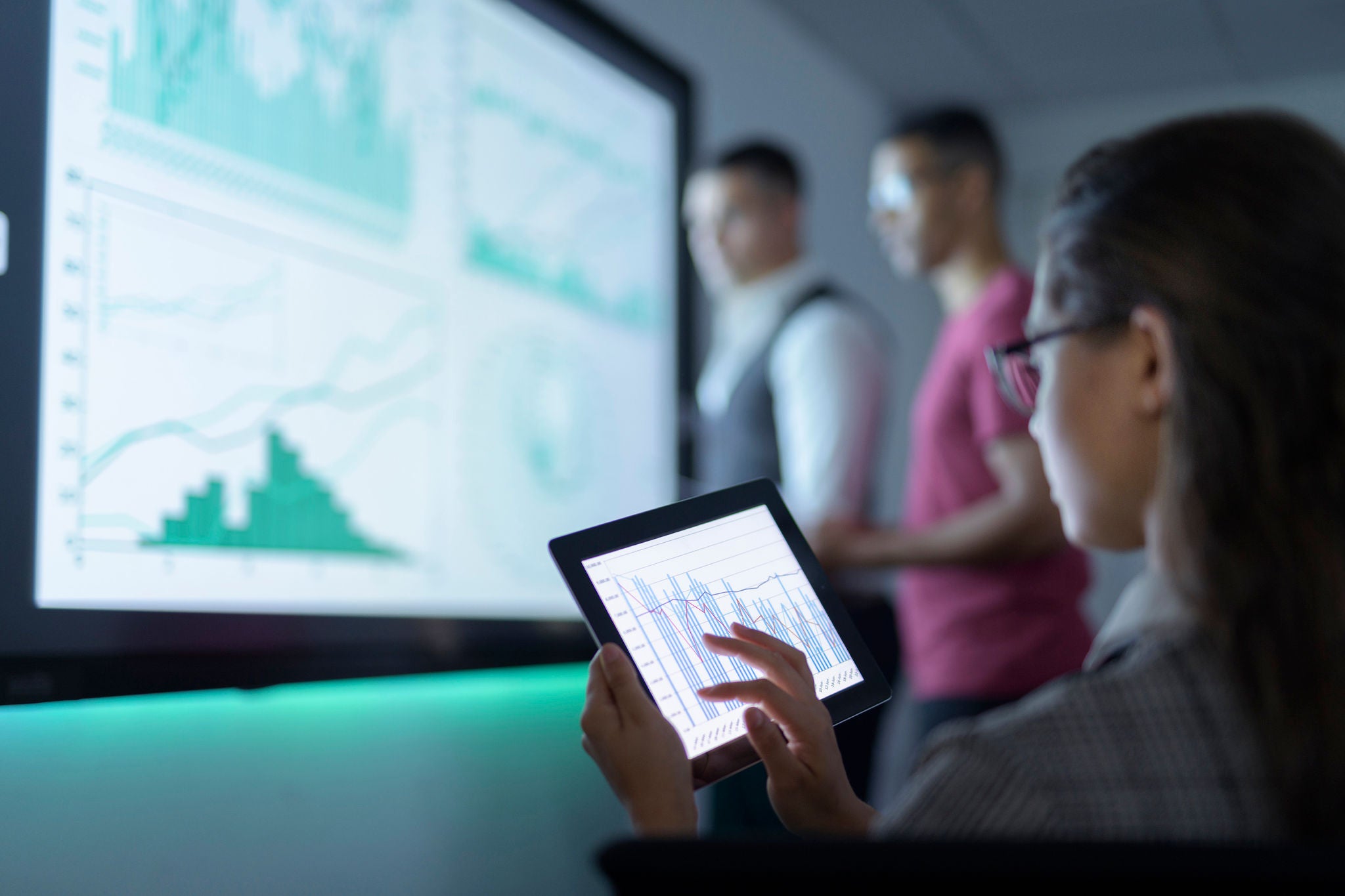 Businesswoman viewing the graphs on digital tablet