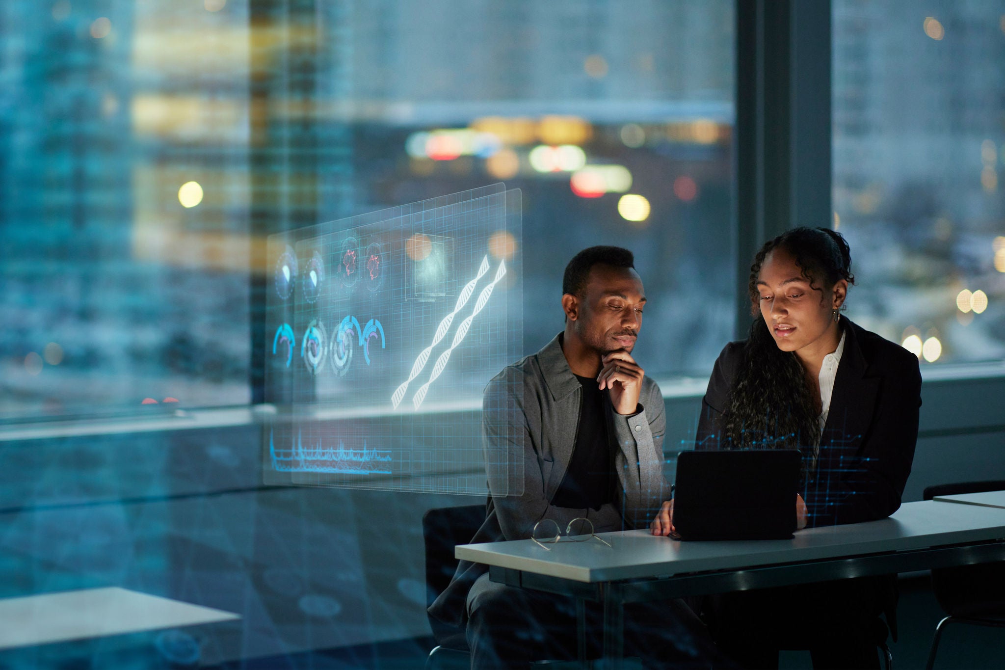 Two young business people working together in office