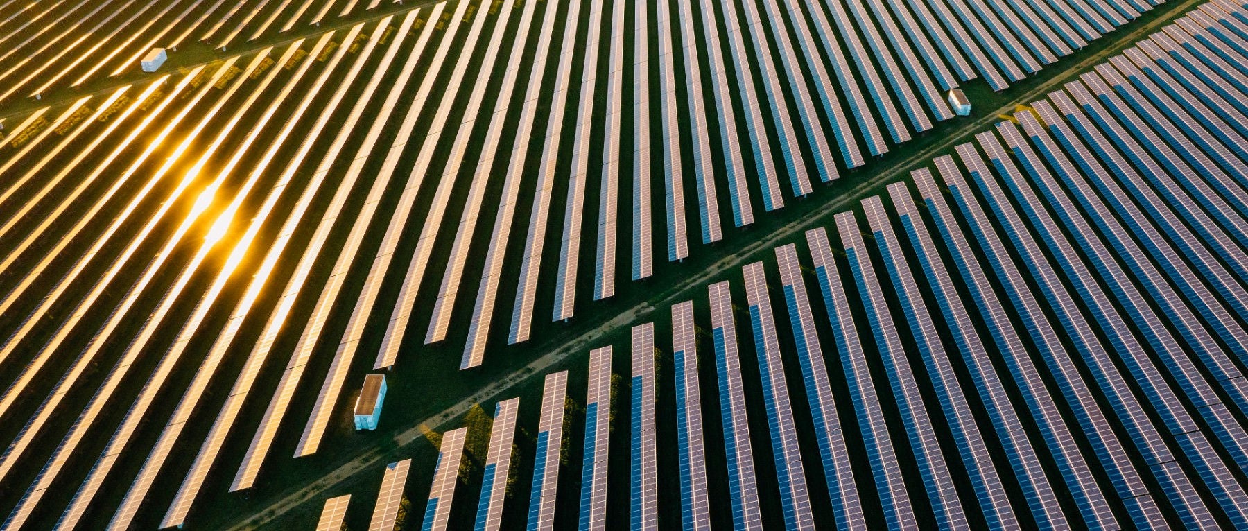 Drone view of a solar panel array close to sunset