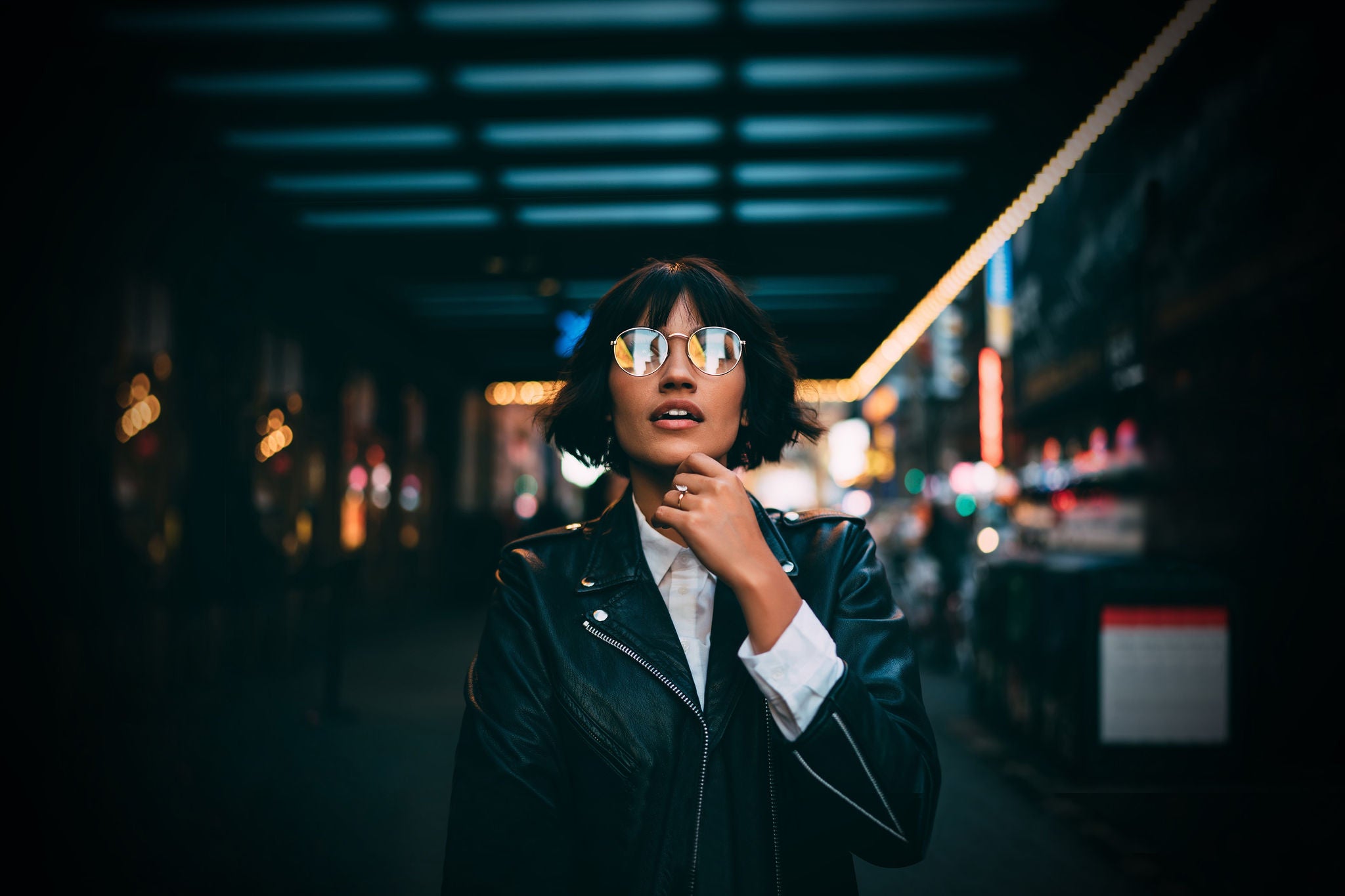 Woman at night in city looking light reflection