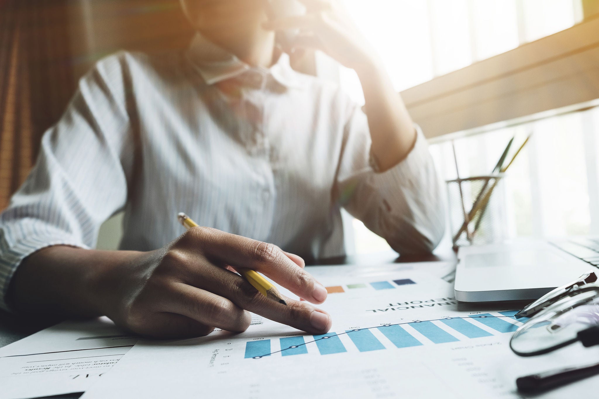 Photo business woman wearing modern white shirt, talking smartphone with accountant consult and holding pencil for calculating tax, financial report, Working with a business graph document report