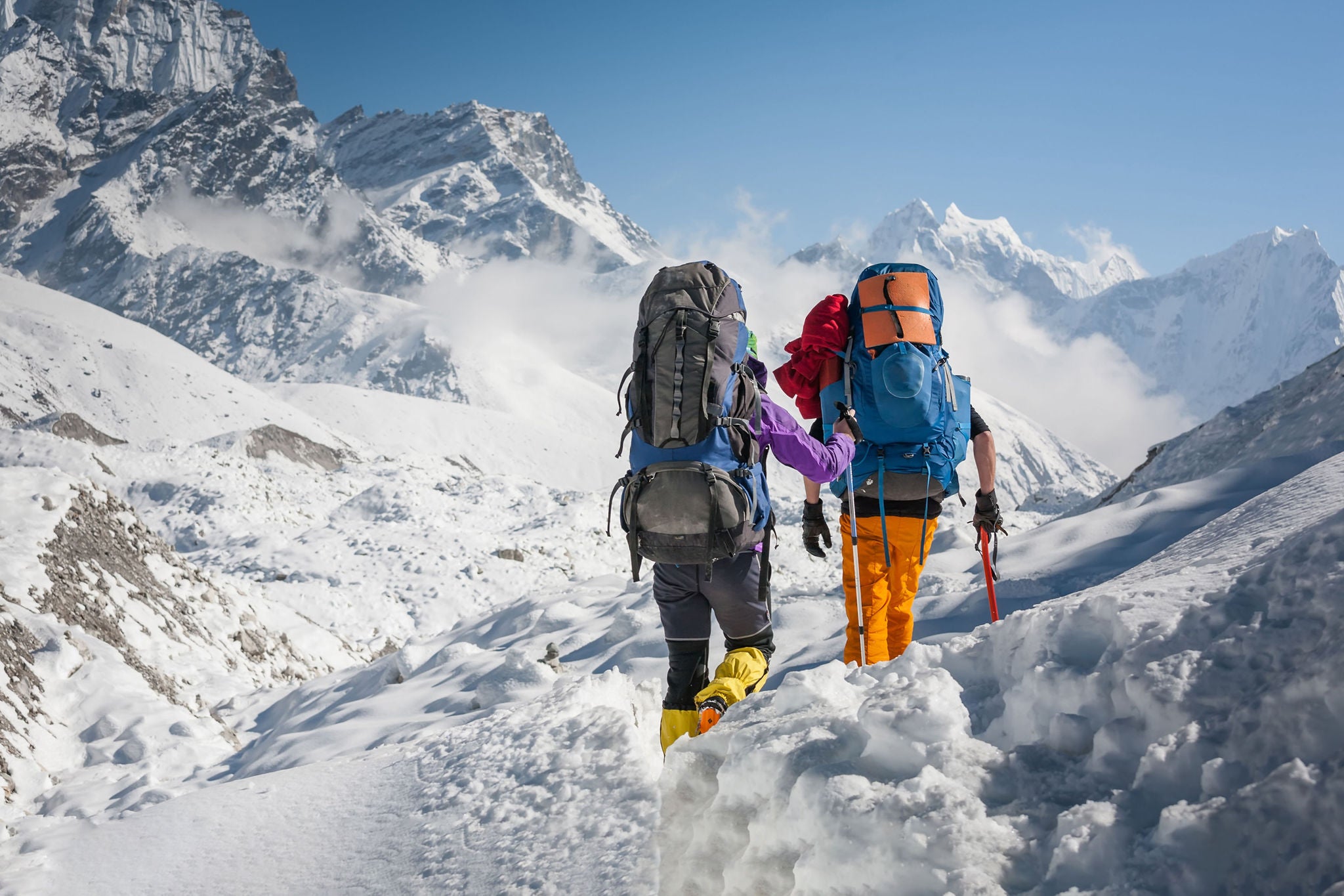 Trekkers crossing Gokyo glacier in Khumbu valley on a way to Everest Base camp