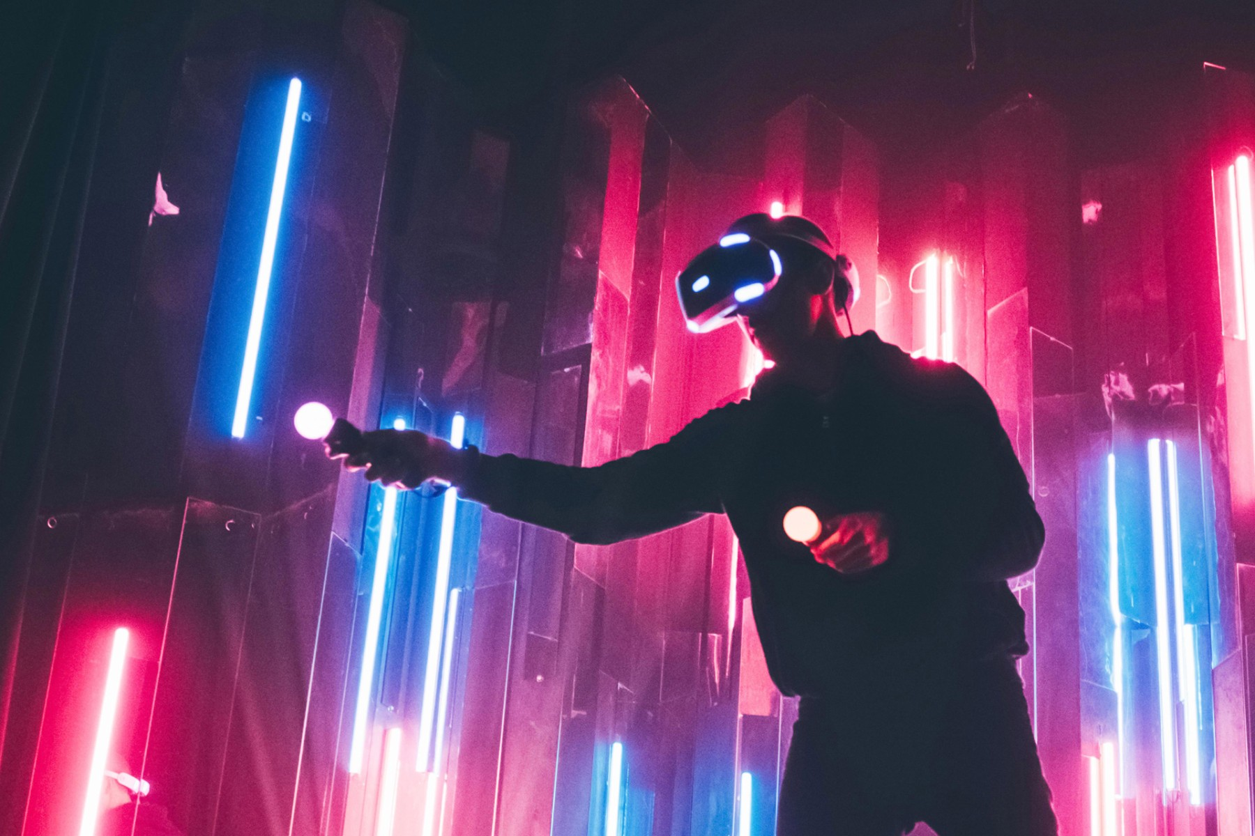 A gamer playing in the metaverse with the glasses and controls with lights