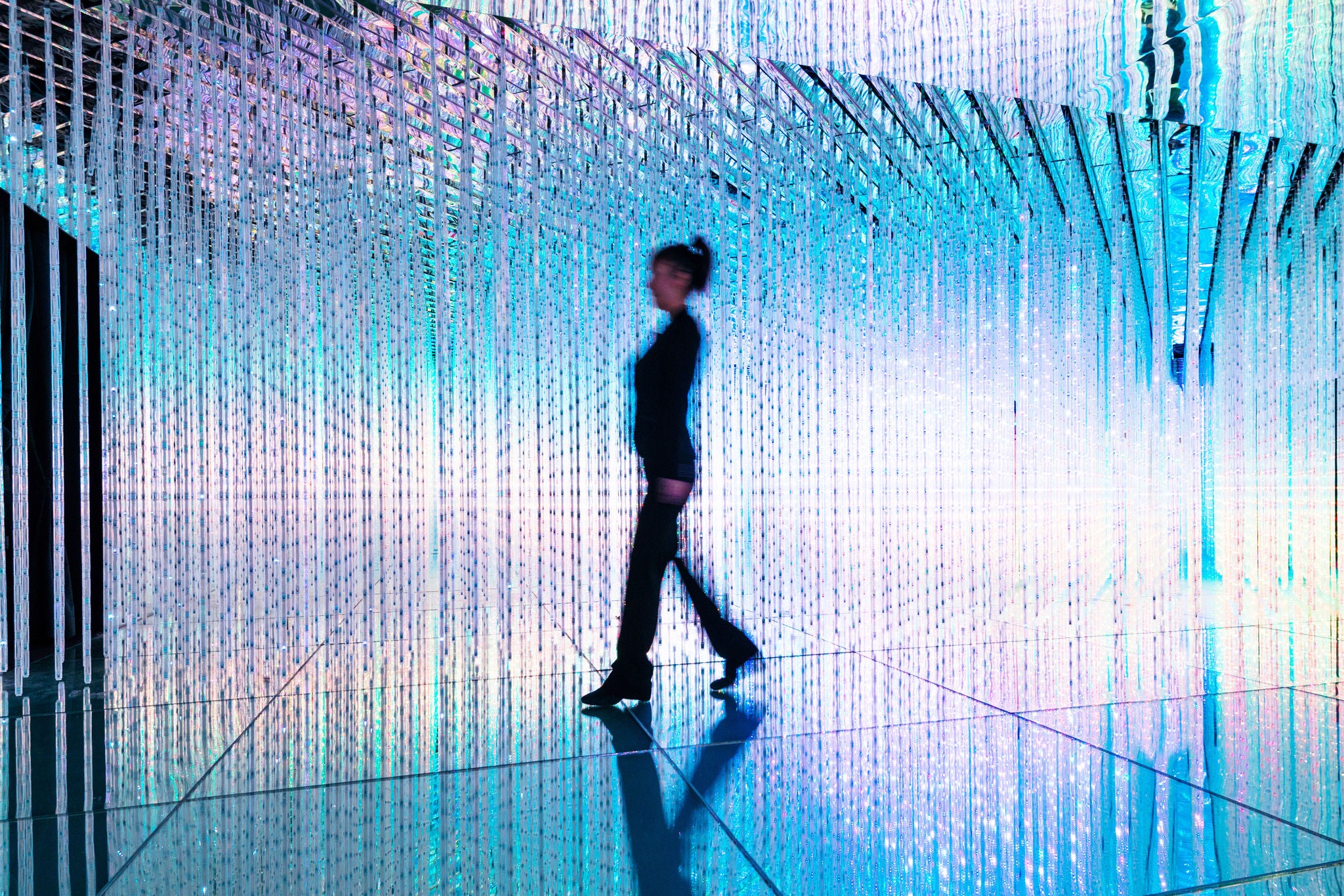 ey businesswoman walking turquise purple lights