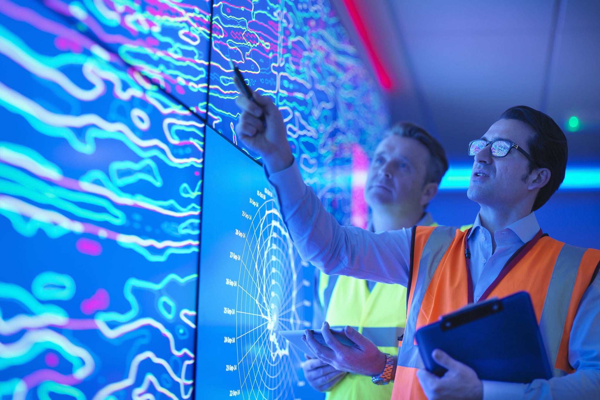 Engineers in front of digital-screen