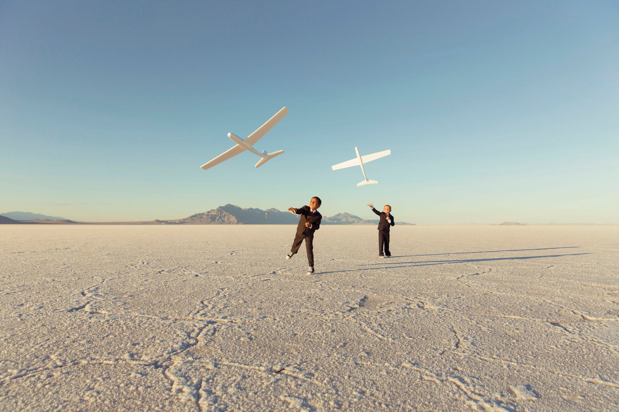 Young Business boys throw toy airplanes 